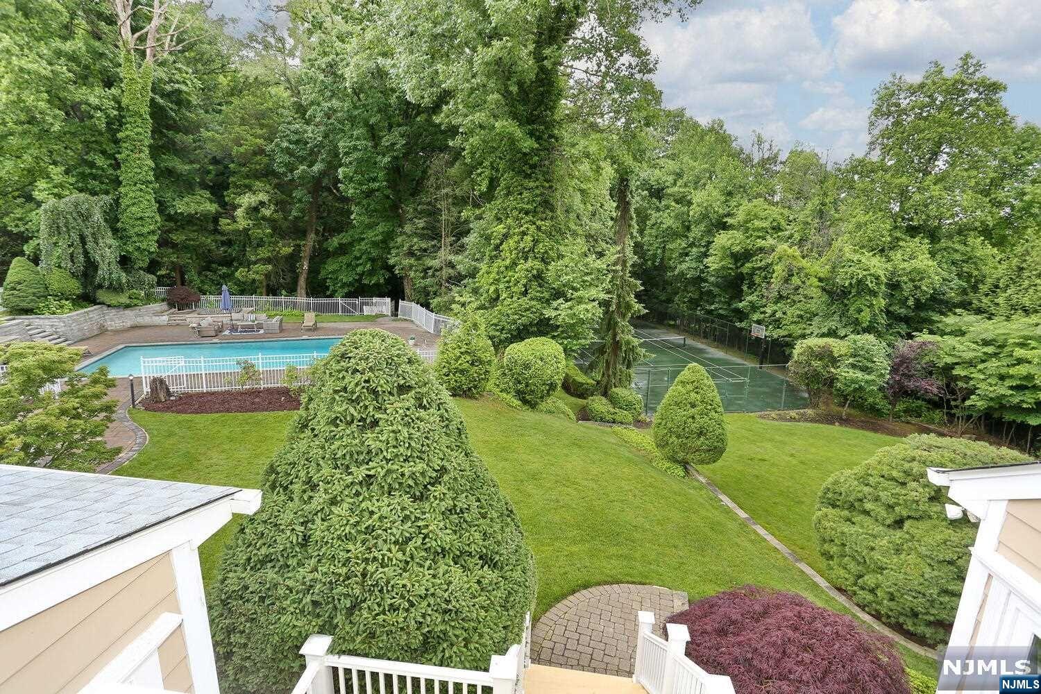 **RARE OFFERING** STATELY EAST HILL COLONIAL on 1.11 acres STUNNING ,ONE OF A KIND BACKYARD !! THIS RESORT STYLE PROPERTY INCLUDES A POOL,2 OUTDOOR KITCHENS , PATIO &TENNIS COURT . RADIANT HEAT IN FOYER, LIBRARYw/ CUSTOM CHERRY PANELS &Coffered Ceiling, L/R w/Gas FPL, Banquet size Dining RM, Family Rm w/Gas FPL, BILLIARD RM w/WET BAR, GORGEOUS BRIGH SUNROOM, Bedroom & Half Bath. GOURMET KITCHEN w/THERMADOR Range & SUB-ZERO ref, RADIANT HEAT, dual Sinks & Dishwashers, Sun-Lit Breakfast RM, SERVICE KITCHEN w/storage sink & refrigeration, F/Bath. SPACIOUS PRIMARY with high ceiling, 2 walking closets ,BALCONY OVERLOOKING PROPERTY. HUGE PRIMARY BATH w/ whirlpool, high ceiling/skylights. 2 Bedrooms w/high/sloping ceilings, 1 w/ENSUITE, 1 additional bedroom and 1 F/Bath. BASMT- a HOME THEATER, Rec Room w/WET BAR, INFARED SAUNA, WINE CELLAR, GYM, Guest Rm/Area, Full Bath & 4 CAR ATTACHED GARAGE. 1 YEAR OLD DRIVEWAY& 6 month old roof/skylights-HIGHLY RANKED SCHOOLS & MIN to NY
