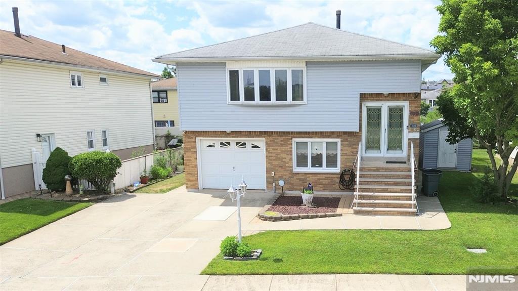 Welcome to 1033 Park Drive, Secaucus, a spacious four-bedroom, 2.5 baths home designed for comfortable living and surrounded by the serene beauty of Mill Creek, nearby parks, schools, a recreation center, and the town pool. This charming property facing east also offers a direct view of the New York skyline, adding to its appeal. Located in a LDR zone (2 family) on a private street with plenty of parking and a short distance to the buses to NYC, shuttle to the Secaucus Junction. The ground features a private on-bedroom, one bath, kitchen, living room with a separate entrance, and sliding doors to a beautiful backyard. The ground level also includes a comfortable family room, a half bath, and a convenient laundry room, which is shared with both floors. The first floor (main level) features a bright and inviting layout with a large living room, formal dining room, eat-in kitchen, three generously sized bedrooms, and a full bath. A lovely fourth room opens to the deck, perfect for relaxing and enjoying the changing seasons. The house has separate electrical boxes, gas heat, and central air. Perfect for a large or extended family, the home combines space, versatility, and a very desirable location.