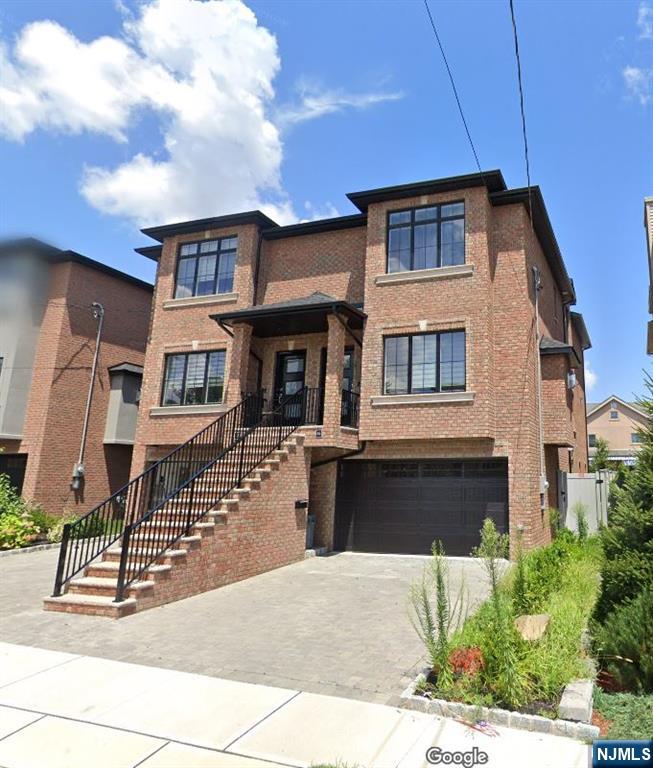 East of Palisade Avenue â€” Cliffside Park's most coveted location. This all-brick townhouse offers three levels of well-planned living space minutes from Manhattan. The main level features a gracious foyer, large living room with gas fireplace, formal dining room, and eat-in kitchen with custom cabinetry, granite counters, and high-end stainless appliances, plus sliding doors to a private deck. Upstairs, the primary suite includes a skylit en-suite bath, joined by two additional spacious bedrooms, a full hall bath, and a dedicated laundry room. The ground level adds flexibility with a family room opening to the backyard, a full bath, and an attached garage. Hardwood floors, central air, and central vacuum throughout. Steps to shopping, dining, and NYC transportation, with easy access to major highways.