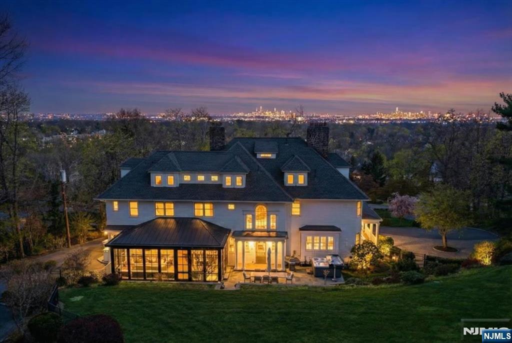 Perched high above Montclair with sweeping, unobstructed views of the New York City skyline, this stunning 8 bedroom,4 full and 3 half bath residence offers a rare blend of timeless charm and modern design. Meticulously maintained, the home honors the elegance of a bygone era while seamlessly embracing today's lifestyle. At its heart is an architect-designed modern kitchen, thoughtfully curated with premium finishes and clean lines, flowing effortlessly into a striking floor-to-ceiling glass familyrm addition. Flooded with natural light from floor-to-ceiling windows, this dramatic space creates an unparalleled setting for both everyday living and entertaining. The primary ensuite is a true retreat, featuring a spa-like bath, spacious walk-in closet, and a private home office overlooking the breathtaking Manhattan skyline. Generous living and dining spaces, rich in character and detail, complement the home's contemporary updates. Eight spacious bedrooms provide flexibility for guests, play and home office needs. Bonus carriage house features a one bedroom apartment above the two car garage. The private setting offers a true sense of retreat, all while being moments from Montclair's vibrant downtown known for its trendy restaurant scene, boutique shopping, beautiful parks and just a few blocks to the NYC train for a seamless commute. A one-of-a-kind offering where classic architecture and modern luxury meet set against a backdrop that simply cannot be replicate.