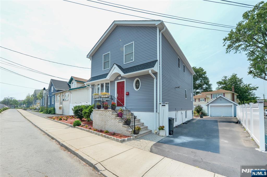 Welcome to 115 Marshall Avenue, where timeless Colonial charm meets modern comfort in the heart of Little Ferry. Perfectly positioned for commuters and just minutes from NYC transportation, major highways, shopping, dining, and the scenic trails of Overpeck County Park, this beautifully maintained 4-bedroom, 3-bath home offers the lifestyle you've been searching for. Step inside to a bright and inviting living room that effortlessly flows into the dining room, where views of the beautifully paved backyard create the perfect backdrop Just beyond, the spacious updated eat-in kitchen is the true heart of the home, featuring rich cabinetry, stainless steel appliances, abundant storage, and plenty of room to cook An updated full bath and a conveniently tucked-away laundry area complete the first floor. Upstairs, you'll find three generously sized bedrooms, including a spacious primary, all sharing a beautifully updated full hall bath. The fully finished basement expands your living space with a private bedroom, full bath, recreation room, summer kitchen, and an additional hidden laundry closet, offering endless possibilities for guests or extended living . Outside, the inviting paver backyard is ready for summer barbecues, quiet mornings, and evenings under the stars. Combining flexible living spaces, thoughtful updates, and an unbeatable location, this is more than just a house,it's the place you'll love coming home to.