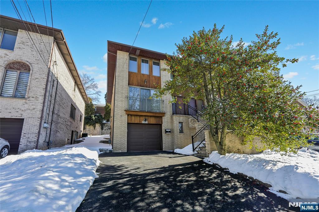 Bright, spacious home (~2400 sq. ft) in desirable quite area of Fort Lee. First floor welcomes you with 2 story entrance foyer, open floor plan living and dining room. Spacious kitchen with stainless steel appliances and granite countertops opens to the dining room and family room with woodburning fireplace and sliding door to the newly built (TREX maintenance free material) deck with BBQ and private backyard. Powder room and guest closet is conveniently located on the 1st floor. Second floor features large primary bedroom with walk in closet and primary bathroom with Toto toilet, bidet, Grohe shower panel, 2 more bedrooms and main bathroom with double sinks, jacuzzi tub, Toto toilet, Grohe shower and Carlo Frattini faucets. The ground floor with the side entrance is full and completely finished. Bedroom and family room on the ground floor was converted to one huge recreation room, but can be converted back. There is also a full bathroom, heated den/storage room, utility room, laundry and garage located on the ground level. Hardwood floors throughout the house, ample closet space, Anderson windows, Hunter Douglas window treatments, CAC, 2 zones baseboard heat. Ring and Nest security systems, Nest thermostat. Perfect for commuters. Close to NYC bus, shopping, community center, school, park and houses of worship. Don't miss this great home!