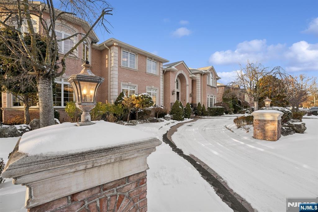 Nestled on Englewood Cliffsâ€™ prestigious North Cliff, this stunning residence combines elegance, warmth, and timeless design. The double-entry foyer welcomes you into a home filled with high ceilings and an abundance of natural light. The first floor features a formal living and dining room, a cozy family room with a fireplace, a large eat-in kitchen, and a mudroom. It also boasts a rare first-floor primary suite with a walk-in closet and a luxurious bath. Upstairs, the second primary suite impresses with high ceilings, a spacious bath, and a walk-in closet. Four additional bedrooms, each with its own walk-in closet and ensuite bath, provide space and privacy. The fully finished lower level offers a recreation area with a fireplace, wet bar, gym, guest bedroom, full bath, and ample storage. Set on a 13,250 sq. ft. lot with low taxes and just minutes from NYC, this elegant home is perfect for modern living and entertaining.