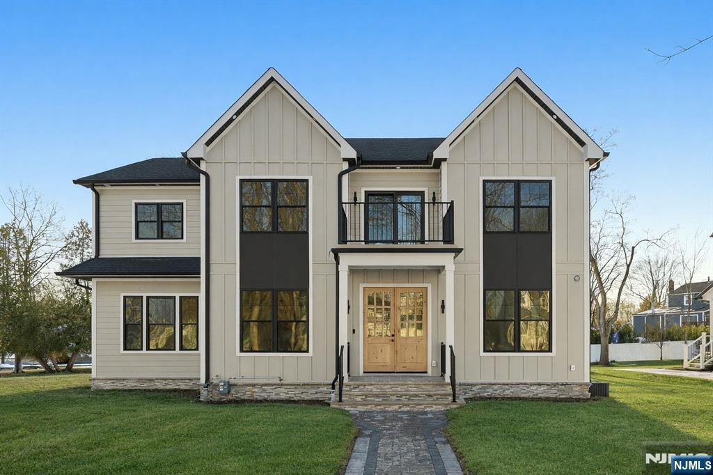 NEW CONSTRUCTION in one of Livingston's most sought-after neighborhoods, this distinguished CENTER HALL COLONIAL offers over 5,100 sq ft of sun-filled living space across 3 beautifully finished levels. A dramatic 2-story foyer sets a grand first impression, highlighted by hardwood floors & custom millwork throughout. The main level is designed for refined living & entertaining, featuring formal living & dining rooms, a spacious family room anchored by a statement FIREPLACE, a stylish powder room, & seamless flow. The gourmet chef's kitchen showcases premium appliances, custom cabinetry, a generous center island, & both a butler's pantry and walk-in pantry. Thoughtfully integrated smart home features, along with a fenced-in backyard & rear porch, extend everyday living outdoors. A private first-floor EN-SUITE bedroom offers comfort & privacy for guests. Upstairs, the primary suite is a serene retreat with a spa-inspired bath, his-and-her walk-in closets, and a private balcony. All additional bedrooms are EN-SUITES, and a second-floor laundry area adds everyday convenience. The fully finished lower level features a recreation room, media or theater room & an additional guest en-suite. A 2-car garage completes this exceptional offering. Additional highlights include designer finishes & a 10-year builder's warranty. Close to schools, shopping, parks, and NYC transportation.