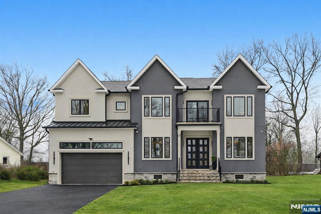 Nestled on a beautifully proportioned, flat 0.36-acre lot backing the golf course in the sought-after Riker Hill section of Livingston, this exceptional NEW-CONSTRUCTION Center Hall Colonial delivers a striking first impression. Offering over 5,500 sq ft of refined living space across three impeccably finished levels, the home features 6 bedrooms and 6.5 bathrooms. A grand 2-story foyer introduces sun-filled interiors accented by hardwood floors & custom millwork throughout. The main level is designed for elegant living & seamless entertaining, showcasing formal living & dining rooms, a stylish powder room, a functional mudroom, & a spacious family room with soaring ceilings and direct access to a paver patio overlooking a private backyard with ideal potential for a future pool. The gourmet kitchen is a true showpiece, appointed with a waterfall-edge quartz island, designer appliances, quartz backsplash, a walk-in pantry, a butler's pantry, & a bright breakfast nook. Upstairs, the primary suite offers a serene retreat with his-and-her custom walk-in closets, a spa-inspired bath with dual vanities, soaking tub, glass-enclosed shower, & a private balcony. Three additional en-suite bedrooms & a well-appointed laundry room complete this level. The finished lower level adds exceptional versatility w/ a recreation room, media room, playroom, & guest en-suite. A two-car garage, builder's 10-year warranty, and close proximity to top-rated schools complete this exceptional offering.