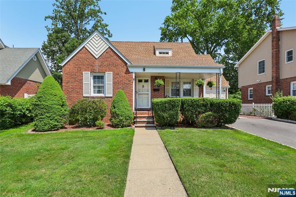 Full of charm, thoughtfully maintained, and improved over the years, this 3-bedroom, 2-full-bath brick Cape Cod offers comfortable living and versatility throughout. The covered front porch opens to a bright living room with hardwood floors and effortless flow into the formal dining room, where sliding doors lead to an oversized deck. A newer kitchen with white cabinetry and stainless steel appliances, two bedrooms with flexibility for an office or den, and a full bath complete the main level. A thoughtful dining room renovation incorporated a portion of the former garage, while the rear remains available for storage - blending expanded living space with everyday practicality. Upstairs, the spacious primary suite provides a private retreat with a full bath, walk-in closet, and office nook. The finished basement offers additional space for recreation, a home office, and storage. Additional highlights include a patio, level fenced backyard, and whole-house generator installed in 2022. Conveniently located near Broadway shopping and dining, NJ Transitâ€™s Broadway Station, Route 4, and nearby parks.