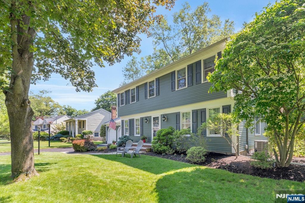 Picture Perfect four-bedroom colonial tucked away on a prime cul-de-sac location boasting a parklike backyard oasis and a sun-drenched four-season room! An absolute turnkey gem! The entry foyer opens into the inviting living room with custom-built-ins and wood floors. The light and bright dining room flows into the classic kitchen with newer appliances, dining area, door to two car garage and glass door to rear deck, ideal for relaxing or entertaining under the open sky! A convenient powder room is next to the family room, which features a brick fireplace, custom accent windows and wood floors. French Doors open to a glorious year-round sunroom with floor to ceiling glass overlooking the lush, fenced yard. Upstairs the front to back primary suite offers a peaceful retreat with spacious walk in closet and full bath. Three additional spacious bedrooms (one with bonus study space) plus an updated full bath provide privacy and comfort to all. The finished lower level has an expansive rec room plus a private office, laundry room, utilities and storage! Beautifully maintained and updated through the years, this home has it all - LOCATION, STYLE, PROPERTY, SPACE, UPDATES and CLOSE TO TOWN, TRAIN, TOP- RATED SCHOOLS, the RAMSEY POOL and MORE!