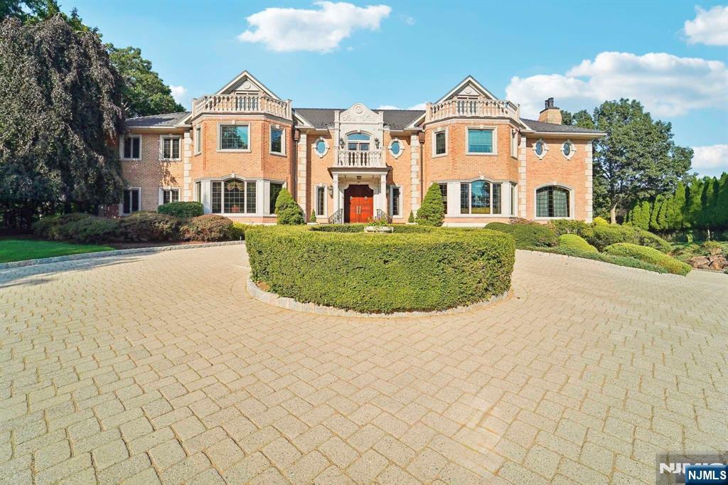 Custom French Chateau estate ideally located on 2.6 acres offering tremendous privacy and views. This stately luxurious home is a 5 bedroom, 6 full, 2 half bath and features handcrafted woodwork throughout. As you enter through the front foyer you are greeted with the breathtaking double bridal staircase. This property is ideal for entertaining guests and offers an oversized great room with countless details inclusive of artwork with hand painted walls and ceilings, mill work, and silk fabric. Large dining room is ready to host the most extravagant meals, professional grade kitchen with two subzero refrigerators, double viking ovens, 8 burner range, 2 miele dishwashers, warming drawer and more. There are 5 en suite bedrooms, heated gunite pool, outdoor kitchen, and terraces. 6 car garage, generator, elevator and sauna are just a few of the many, many extras. This home is an absolute must see and will exceed all expectations. Owner willing to provide a design credit at closing.