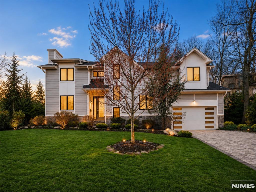 This stunning 5-bedroom Colonial by Lumaj Builders is tucked away on a quiet street in highly sought-after Cresskill. Built only 4 years ago and thoughtfully upgraded throughout, the home offers a bright living room with fireplace, formal dining room, eat-in kitchen, powder room, mudroom, and attached 2-car garage. The second floor features a spacious primary suite with walk-in closet and a luxurious primary bath with radiant heated floors, plus an en-suite bedroom, two additional bedrooms, and a Jack-and-Jill bath. The beautifully finished lower level includes a bedroom, full bathroom, wet bar, recreation area, and pre-installed dehumidifier, making it ideal for both everyday living and entertaining. Additional highlights include radiant heated bathroom floors, whole-house sound system, full-house generator, Google Nest smart-home wiring, Nest doorbell, central vacuum, Tesla EV charger, and a brand-new dishwasher. Outside, enjoy a private backyard with a patio, perfect for relaxing or entertaining. Located in a wonderful town with excellent schools and easy access to NYC, this home offers the perfect blend of luxury, comfort, and convenience.
