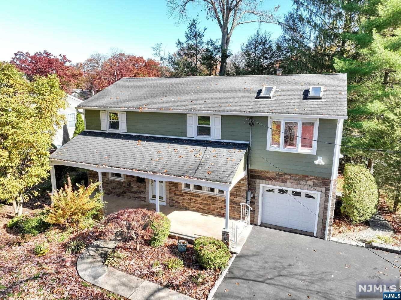 Lovely center hall colonial with great curb appeal. Entry foyer, large living room, formal dining room, expanded eat-in kitchen and solarium area. Door to deck. Powder room. Second floor boasts a large primary suite with skylights, primary full bath and two large closets. Three other bedrooms and full main bath complete the second floor. Beautiful property with large trex deck. Hillsdale offers top schools, transportation to NYC. Roof 7 years old.