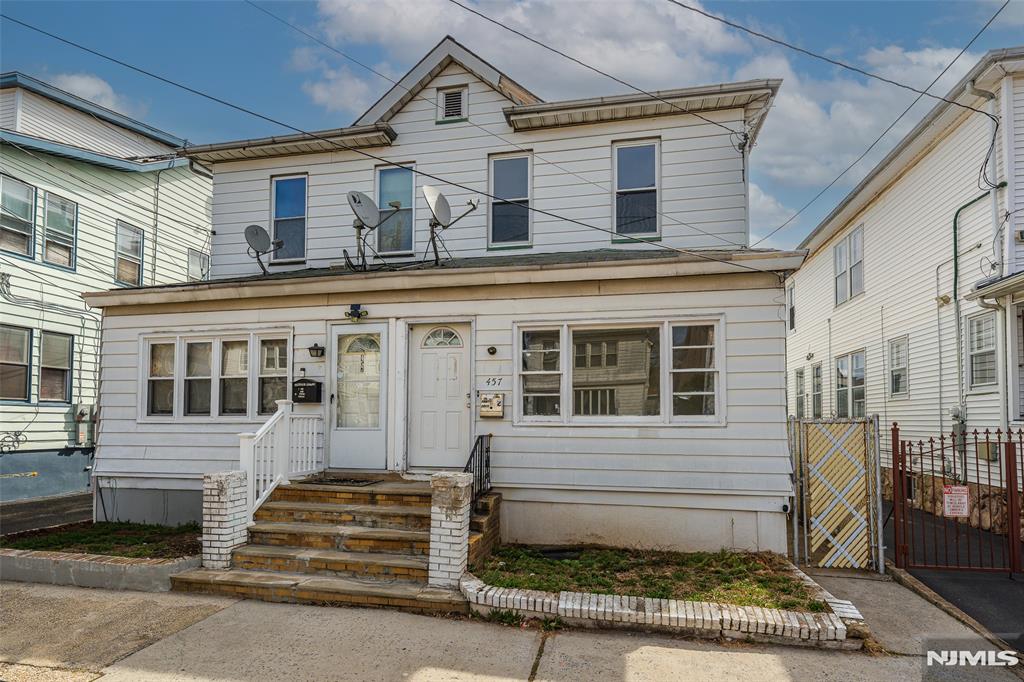 Opportunity meets location on Newark's desirable North Side! This duplex-style single-family home offers incredible potential for the right buyer looking to add value and make it their own.The main level features a spacious living room, formal dining room, and an eat-in kitchen, along with a full bath conveniently located on the first floor. Upstairs, you'll find three bedrooms and an additional full bath, providing a practical and flexible layout. This home also features new windows, bringing in great natural light and adding to the overall value. Enjoy the charm of an enclosed front porch perfect for relaxing or creating a welcoming entry space along with a nice-sized, low-maintenance cement backyard ideal for outdoor seating or entertaining without the upkeep. A partially finished basement offers additional space for storage, recreation, or future customization, while the detached garage provides convenient parking and extra storage. The property does need TLC, making it a great opportunity for investors or buyers looking to renovate and build equity. With the added benefit of low taxes, this home becomes an even more attractive long-term investment. Ideally located just 0.3 miles from the Bloomfield Light Rail Station and only about a 10-minute drive to Newark Penn Station, this home is perfect for commuters seeking accessibility and long-term upside.
