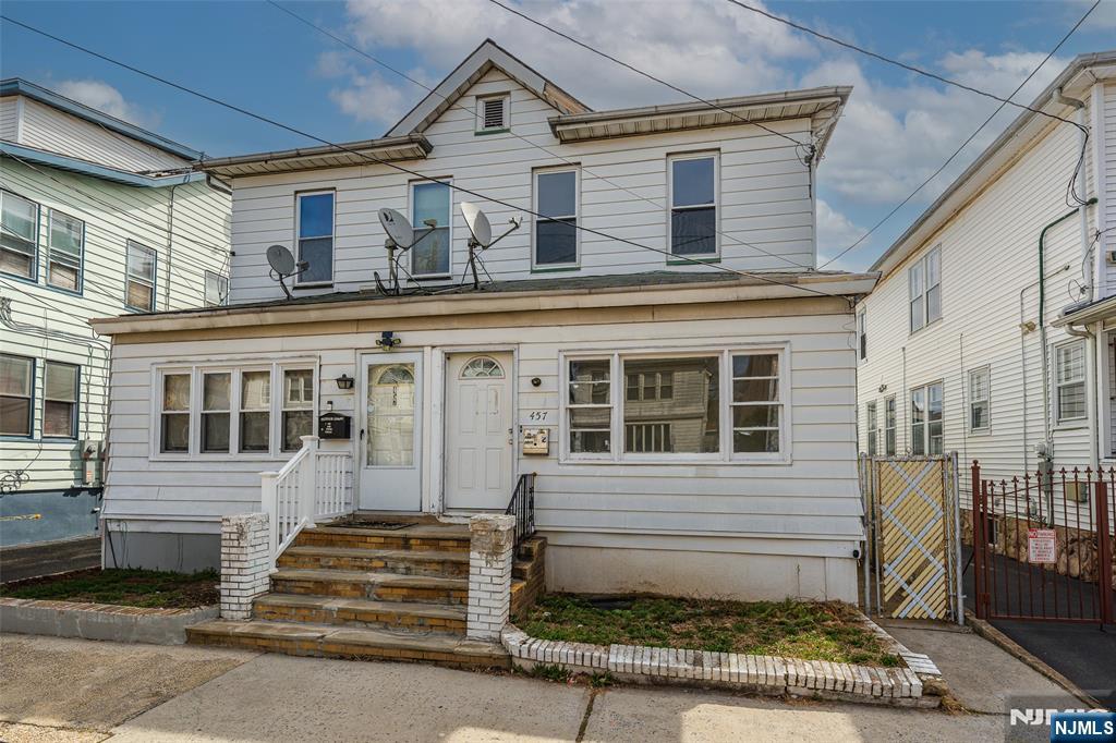 Opportunity meets location on Newark's desirable North Side! This duplex-style single-family home offers incredible potential for the right buyer looking to add value and make it their own.The main level features a spacious living room, formal dining room, and an eat-in kitchen, along with a full bath conveniently located on the first floor. Upstairs, you'll find three bedrooms and an additional full bath, providing a practical and flexible layout. This home also features new windows, bringing in great natural light and adding to the overall value. Enjoy the charm of an enclosed front porch perfect for relaxing or creating a welcoming entry space along with a nice-sized, low-maintenance cement backyard ideal for outdoor seating or entertaining without the upkeep. A partially finished basement offers additional space for storage, recreation, or future customization, while the detached garage provides convenient parking and extra storage. The property does need TLC, making it a great opportunity for investors or buyers looking to renovate and build equity. With the added benefit of low taxes, this home becomes an even more attractive long-term investment. Ideally located just 0.3 miles from the Bloomfield Light Rail Station and only about a 10-minute drive to Newark Penn Station, this home is perfect for commuters seeking accessibility and long-term upside.
