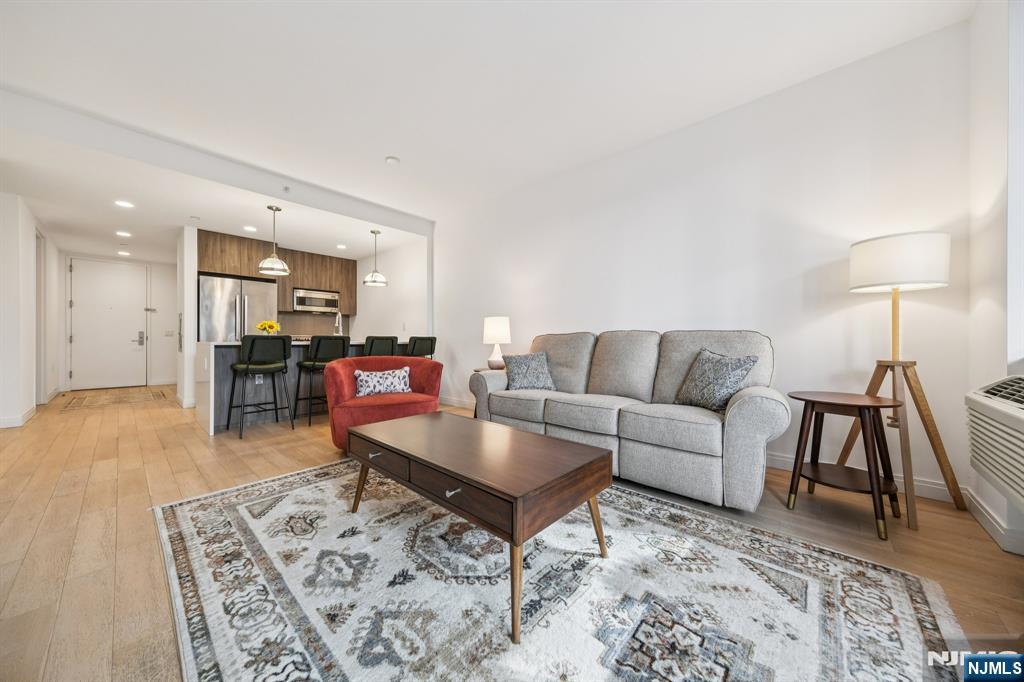 Discover sophisticated city living in this bright and spacious one-bedroom plus den residence at The Oakman, one of Downtown Jersey City's premier luxury condominiums. A private terrace extends your living space outdoors, offering the perfect retreat for morning coffee. Inside, every detail has been thoughtfully crafted, from the wide-plank white oak floors to the custom Italian Pedini cabinetry. The gourmet kitchen is equipped with high-end appliances by Bertazzoni, Bosch, and Miele, while sleek fixtures from Kohler and Hansgrohe add a refined touch. Oversized windows fill the home with natural light, creating an airy, comfortable atmosphere that feels both modern and welcoming. Residents of The Oakman enjoy resort-style amenities including a rooftop pool with BBQ grills, a state-of-the-art fitness center, children's playroom, resident lounge with fireplace, library, and convenient bike and cold storage. A 24-hour concierge and on-site garage parking (available for a fee) complete the full-service experience. Located just three blocks from the Grove Street PATH, The Oakman offers an easy commute to Manhattan and immediate access to Jersey City's best restaurants, caf s, and shops. With an abatement in place through 2036, this home combines luxury, convenience, and exceptional value in the heart of Downtown Jersey City.