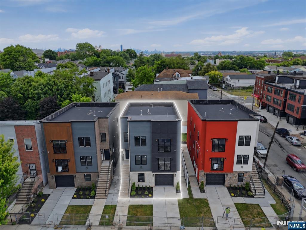 The multifamily game has changed, and these homes are proof of it. Designed with intention and built to stand apart, this is anything but your typical new construction. Every detail has been carefully curated, from the striking facade contrasts and unique architectural designs to the thoughtfully planned landscaping, all tailored to complement today's lifestyle. We are fortunate to offer only three of these exceptional residences. The wait is over. Welcome to these beautifully sized homes featuring a ground level designed for both functionality and entertaining, complete with an open flex space, a half bathroom, elegant tile work throughout, a two car tandem garage, and sliding doors leading to your private paved patio and grassy backyard. Each home offers two spacious apartments, with every unit featuring three bedrooms and two full bathrooms, including a primary suite. Unique accent walls, designer finishes, Juliet balconies, oversized living areas, and stunning kitchens with abundant cabinetry and peninsula seating complete the experience. Offering a total of six bedrooms and five and a half bathrooms, these homes are conveniently located near major highways, airports, public transportation, shopping, and more. You need to see them in person to truly appreciate everything they have to offer. *** 5 YEARS TAX ABATEMENT *** LAST ONE AVAILABLE ***