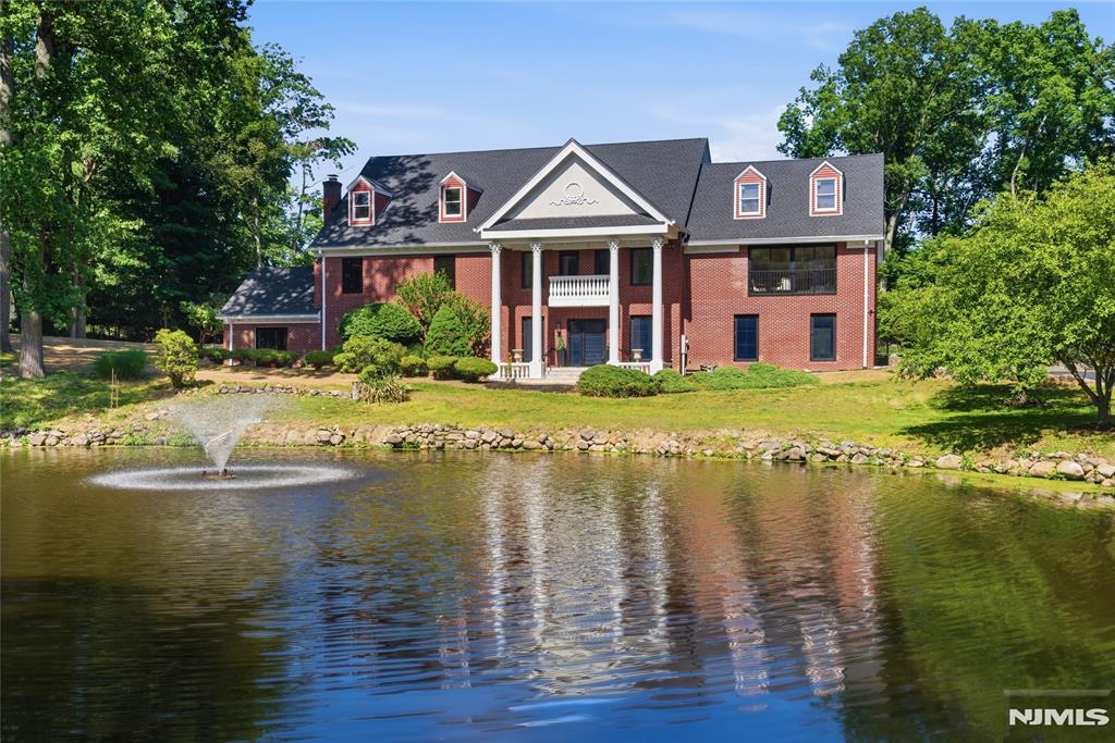 Welcome to this fully renovated grand brick colonial in Upper Saddle Riverâ€™s sought-after Northern Highlands school district. Set on a tree-lined street with serene pond views, this 5-bedroom, 4 full and 1 half bath residence offers over 5,696 sq ft of refined living space, plus an unfinished third level with 1,600+ sq ft of high-ceiling recreational potential. Recently transformed with major luxury upgrades, the home features a new roof, HVAC, septic, full-house filtration, custom windows and doors, frameless garage doors, 6-inch white oak floors, high-end appliances, custom millwork, new bathrooms, wet bar, wine rack, and designer finishes throughout. A dramatic foyer and grand staircase lead to formal living and dining rooms, private study, spacious family room with fireplace, beautifully appointed kitchen, and bright breakfast area. Custom full-opening sliding glass doors create seamless indoor-outdoor flow to the patio, grounds, and pond views. Upstairs, 5 bedrooms include a luxurious primary suite with vaulted ceilings, walk-in closet, spa-like bath, steam shower, soaking tub, and private retreat feel. The third level offers rare flexibility for a theater, golf simulator, gym, lounge, wet bar, or recreation space. Complete with level grounds, landscape design ready, 3-car garage, whole-house generator, and convenient access to shops, restaurants, Route 17, and NYC transportation, this renovated estate delivers space, quality, and lifestyle in one exceptional home!