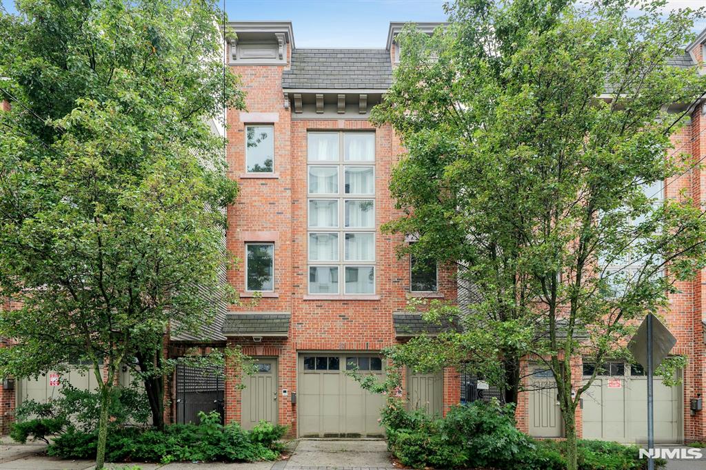 Large loft-style brick duplex on a desirable Jersey City block featuring a bright, open layout with oversized windows, 9-foot ceilings, and a dramatic 19-foot lofted space. First level includes a modern kitchen with breakfast bar, granite countertops, stainless steel appliances, and a powder room. Upper level offers a primary bedroom with en-suite bath, a second bedroom, a full hall bath, in-unit laundry, and abundant closet space. Enjoy a deeded, private roof deck with NYC skyline viewsâ€”perfect for entertaining. One-car garage parking included. Gas heat and central air. Prime location close to NYC transportation, shops, and restaurants.