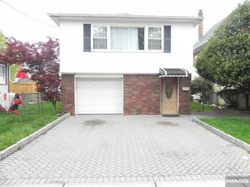PRICE REDUCED----THIS 4 BEDROOM, 2 FULL BATH HOME FEATURES ON THE 1ST FLOOR A SPACIOUS LIVING ROOM, DINING ROOM, NICE SIZE KITCHEN, 3 BEDROOMS AND A FULL BATH#1. THE GROUND FLOOR FEATURES AN OPEN LIVING ROOM/EAT IN KITCHEN, BEDROOM #4, FULL BATH #2, LAUNDRY ROOM, UTILITY CLOSET AND ENTRANCE TO THE GARAGE AND A BACK YARD DOOR TO THE LARGE OUTDOOR CEMENT PATIO. OTHER FEATURES IN THE HOME ARE 1ST FLOOR FULL BATH RENOVATED 1 YEAR AGO, 1ST FLOOR HAS HARDWOOD FLOORS, GROUND FLOOR HAS TILE FLOORS. FENCED IN BACKYARD, CLOSE TO EVERYTHING---SCHOOLS, PARKS, SHOPPING, HOUSE OF WORSHIP, NYC TRANSPORTATION AND MORE.
