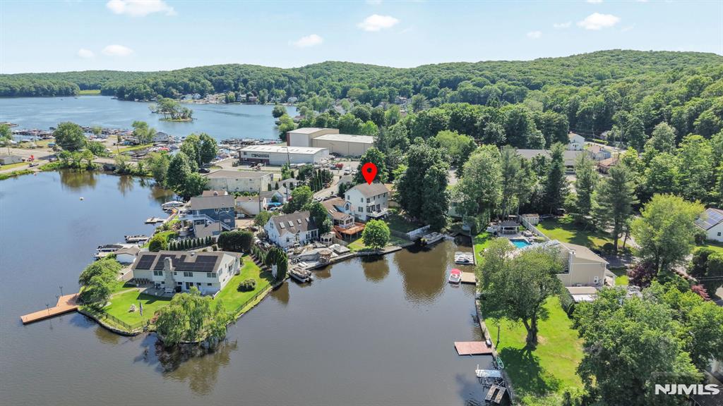 Rare lakefront Colonial on Brights Cove, Lake Hopatcong â€” quality built in 2005 and move-in ready. Level lot with dock, bulkhead & easy access to the main lake. The open floor plan is bathed in natural light with panoramic cove views from the entire back of the home through double sliders and oversized windows. Dream kitchen features maple cabinetry, granite countertops & center island. Gleaming hardwood floors, ceramic tile & carpeting throughout. 2 bedrooms plus a den & 2.5 baths â€” master suite boasts private bath & second-tier balcony overlooking the lake & mountains. Convenient laundry in the second floor hall bath. Recessed lighting, central A/C, hot water baseboard heat, city water, septic. The full walk-out basement is an entertainer's dream â€” featuring a built-in bar, generous open space for gatherings, a private entrance for guests, and a full interior stairway. High ceilings, no columns, and a huge floored attic round out this exceptional home. Fully fenced yard. Deck overlooking the cove â€” perfect for entertaining. Already have a boat or dreaming of owning one someday? Your private dock & bulkhead are ready and waiting â€” cruise to lakeside restaurants, shops & marinas right from your backyard. Minutes to Rt. 15, major highways & Mt. Arlington Train Station. This is lake life at its finest â€” don't miss it!