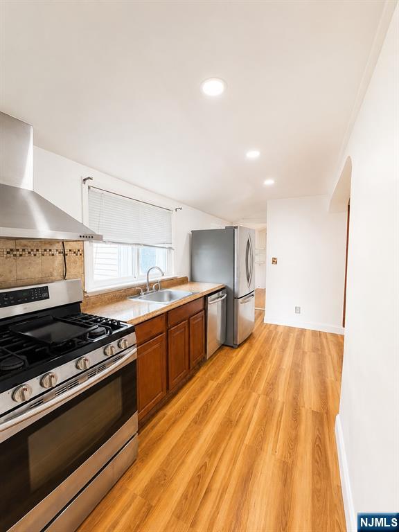 Freshly painted, first floor 3 apartment. 1 driveway parking spot included, other cars side street parking. Laundry on premises. This apartment consists of a renovated kitchen with stainless steel appliances, spacious living area and dining room. Hardwood floors throughout, updated bathroom and half bath, plenty of windows and closet space. All utilities are separate. Close to NYC transportation and shopping. NO PETS.