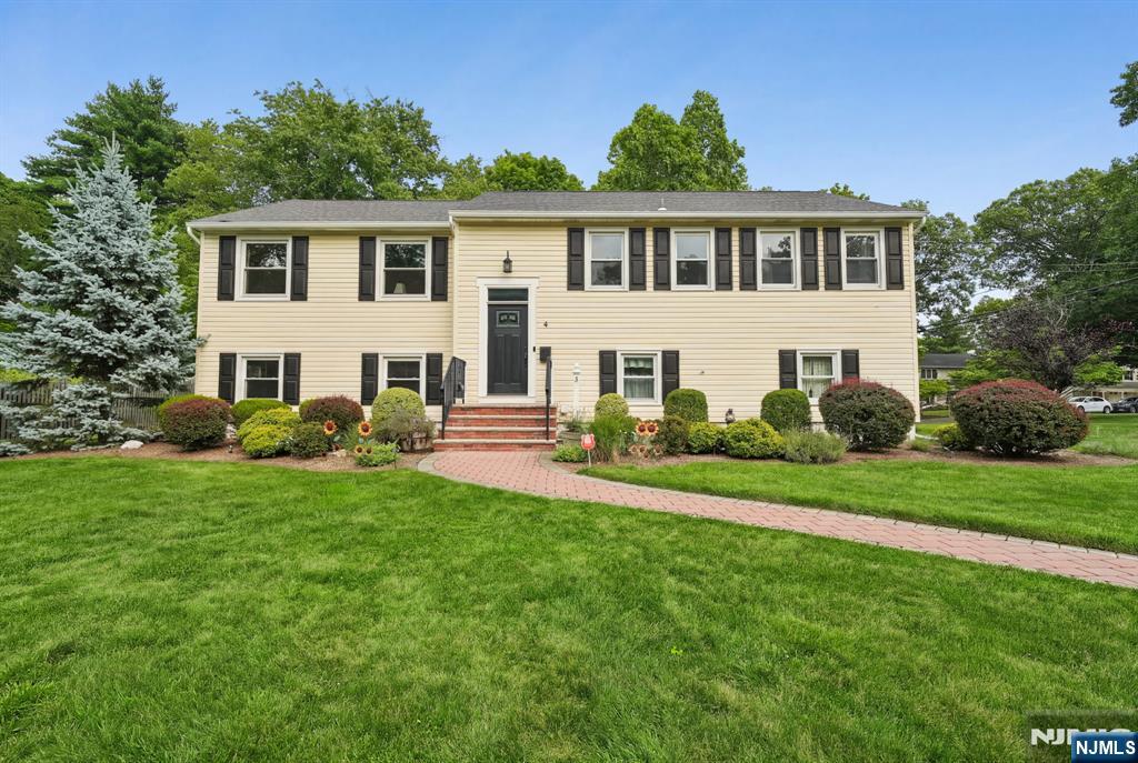 This beautifully updated, sun-filled 4-bedroom, 2 1/2 bath home offers the ultimate blend of versatile living and modern convenience. Gleaming wood floors, recessed lighting, a sleek eat-in kitchen (2018) features stainless steel appliances and premium countertops. Thoughtfully designed, this rare bilevel home has a second staircase off the kitchen that leads to the lower level. The primary suite features an updated private bath. The expansive ground-level space is complete with family room displaying full wall built ins and shelving, guest suite/ fourth bedroom, laundry, bath and direct access to the oversized two car garage and backyard. Updates include newly paved driveway in 2019, new roof in 2020, walkway 2016, windows 2015, hot water heater in 2023, new electric panel 2017. Located just minutes from Livingston's top-rated schools, NYC transit, houses of worship, parks and local shopping.