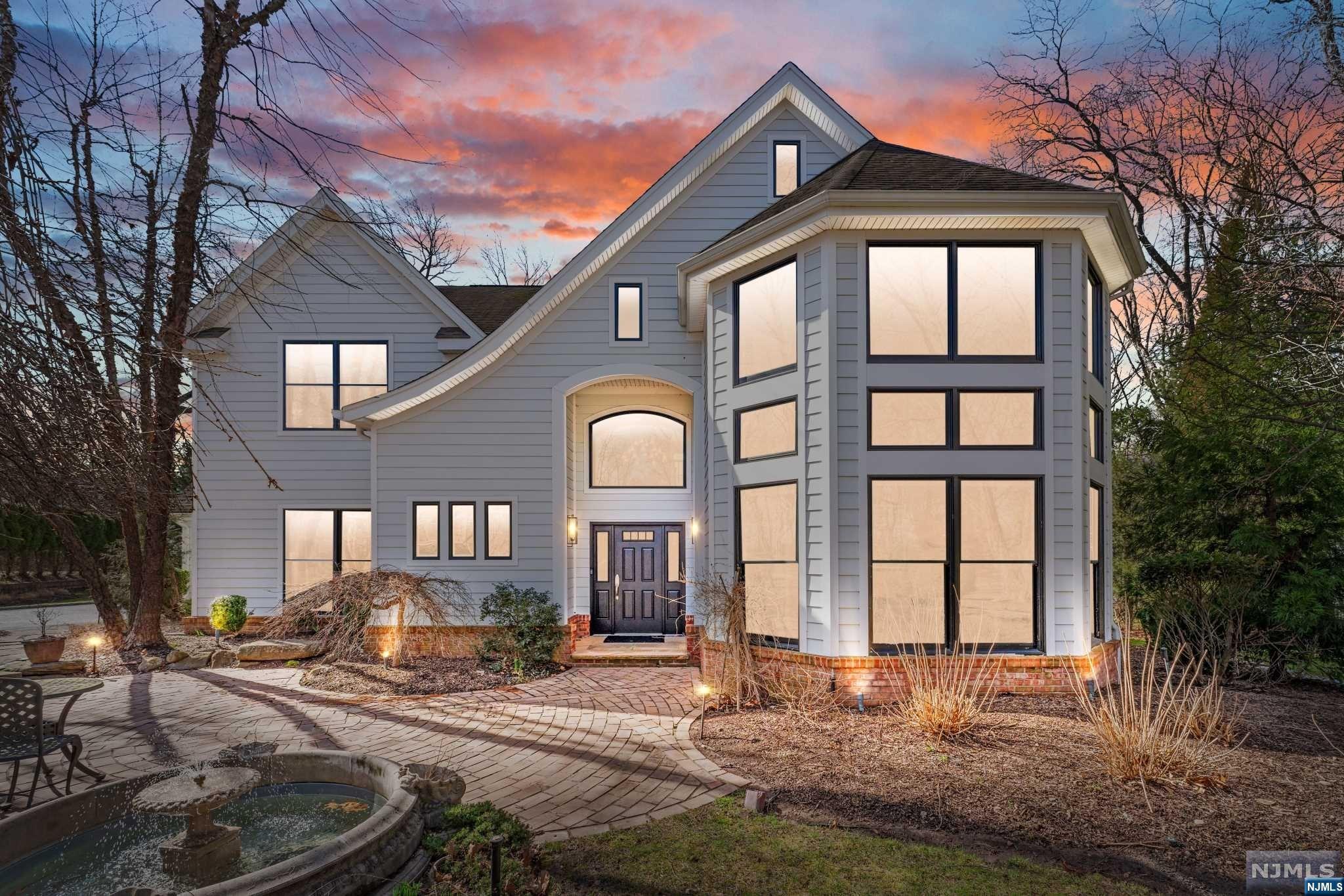 Step into this exquisite CUSTOM center hall colonial, blending classic elegance with modern luxury. Boasting 7,000+/- SF, 5 BEDS / 4.2 BATHS across three finished levels, this home rests on a tranquil cul-de-sac near top-rated schools & NYC transportation. A stunning two-story foyer welcomes you to an open-concept layout. The renovated gourmet kitchen features high-end appliances, a dry bar, and a butler's pantry, extending to a backyard patio with an outdoor kitchen and firepit. A double-sided fireplace connects the living and family rooms, creating a cozy atmosphere. A 2016 rear addition adds a mudroom, laundry, garage access, and a game room with vaulted ceiling and wet bar. Upstairs, the primary suite offers a spa-like bath and expansive closet, with three additional bedrooms and 2 full baths. The finished lower level includes a guest suite, office, gym, wine cellar, media room, and storage. This home promises unmatched convenience and luxury living.