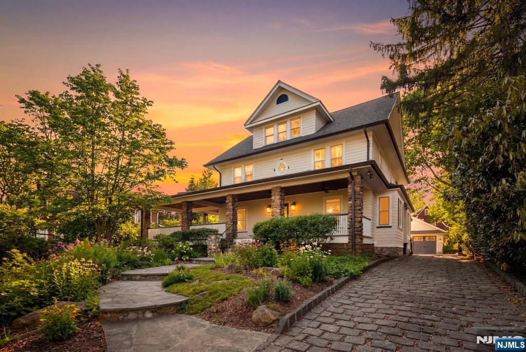 Set on approximately half an acre in the coveted Prospect Park section of Glen Rock, this exceptional home blends timeless craftsmanship with refined modern updates across four full levels. A breathtaking 1,000 sq ft wraparound mahogany porch with stone columns creates a striking first impression and an unparalleled setting for outdoor living. Inside, soaring ceilings and rich architectural details frame a banquet-sized dining room and a stunning gourmet kitchen with custom breakfast nook featuring built-in storage and clever design touches including pull-out spice racks and bench drawers. High-end appliances include a Wolf range, steam oven, double refrigerator. The kitchen opens to a sun-filled family room with remote-controlled skylights. The luxurious primary suite features a newly renovated spa-like bath. A private office, spacious bedrooms, and a third-floor retreat add flexibility. The finished lower level offers recreation space, gym with shower, second laundry, and updated finishes including epoxy flooring. Outdoors, enjoy a flagstone patio with outdoor kitchen and a deep, private yard. Above the garage, a versatile bonus space offers endless potentialâ€”ideal for a hangout, creative studio, or additional living area. A rare opportunity in one of Glen Rockâ€™s most desirable neighborhoods with top-rated schools.