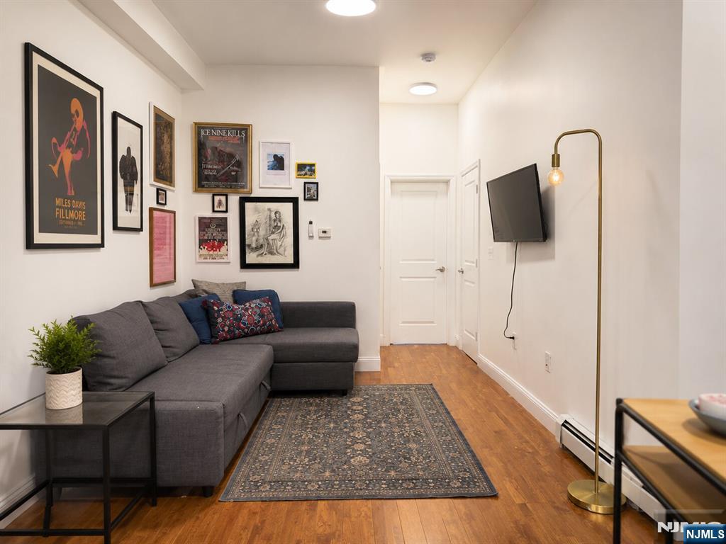 Welcome to this bright and thoughtfully designed residence in the heart of Jersey City Heights, one block away from Central Ave, complete with an ASSIGNED PRIVATE PARKING SPACE, an incredibly valuable and rare feature in Jersey City. This home offers easy access to parks, cafes, restaurants, shopping, and public transportation to Hoboken and NYC. This unit offers a blend of modern comfort, high ceilings, and stylish finishes, creating a warm and inviting living space with an airy loft-like feel. The included deeded parking spot adds exceptional convenience, ease, and long-term value for both homeowners and investors. Features oversized windows that bring in abundant natural light, wide-plank hardwood floors throughout, and an efficient open layout that maximizes both functionality and comfort. The spacious living area flows seamlessly into a modern kitchen equipped with white shaker cabinetry, stainless steel appliances, granite countertops, and ample storage. The bedrooms offer impressive ceiling height and a clean, minimalist aesthetic, comfortably accommodating a full bedroom setup while maintaining an open and relaxing atmosphere. The bathroom is updated with contemporary finishes and a clean modern design, and ample closet space. A fantastic opportunity to own a stylish, move-in-ready home with the added luxury of dedicated parking in one of Jersey Cityâ€™s fastest-growing neighborhoods.