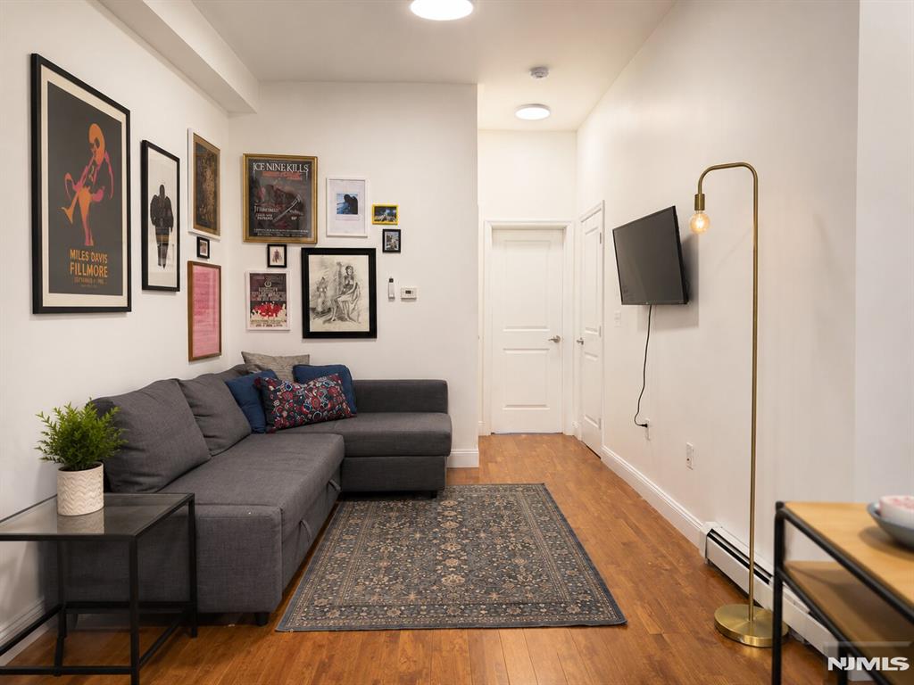 Welcome to this bright and thoughtfully designed residence in the heart of Jersey City Heights, one block away from Central Ave, complete with an ASSIGNED PRIVATE PARKING SPACE, an incredibly valuable and rare feature in Jersey City. This home offers easy access to parks, cafes, restaurants, shopping, and public transportation to Hoboken and NYC. This unit offers a blend of modern comfort, high ceilings, and stylish finishes, creating a warm and inviting living space with an airy loft-like feel. The included deeded parking spot adds exceptional convenience, ease, and long-term value for both homeowners and investors. Features oversized windows that bring in abundant natural light, wide-plank hardwood floors throughout, and an efficient open layout that maximizes both functionality and comfort. The spacious living area flows seamlessly into a modern kitchen equipped with white shaker cabinetry, stainless steel appliances, granite countertops, and ample storage. The bedrooms offer impressive ceiling height and a clean, minimalist aesthetic, comfortably accommodating a full bedroom setup while maintaining an open and relaxing atmosphere. The bathroom is updated with contemporary finishes and a clean modern design, and ample closet space. A fantastic opportunity to own a stylish, move-in-ready home with the added luxury of dedicated parking in one of Jersey Cityâ€™s fastest-growing neighborhoods.