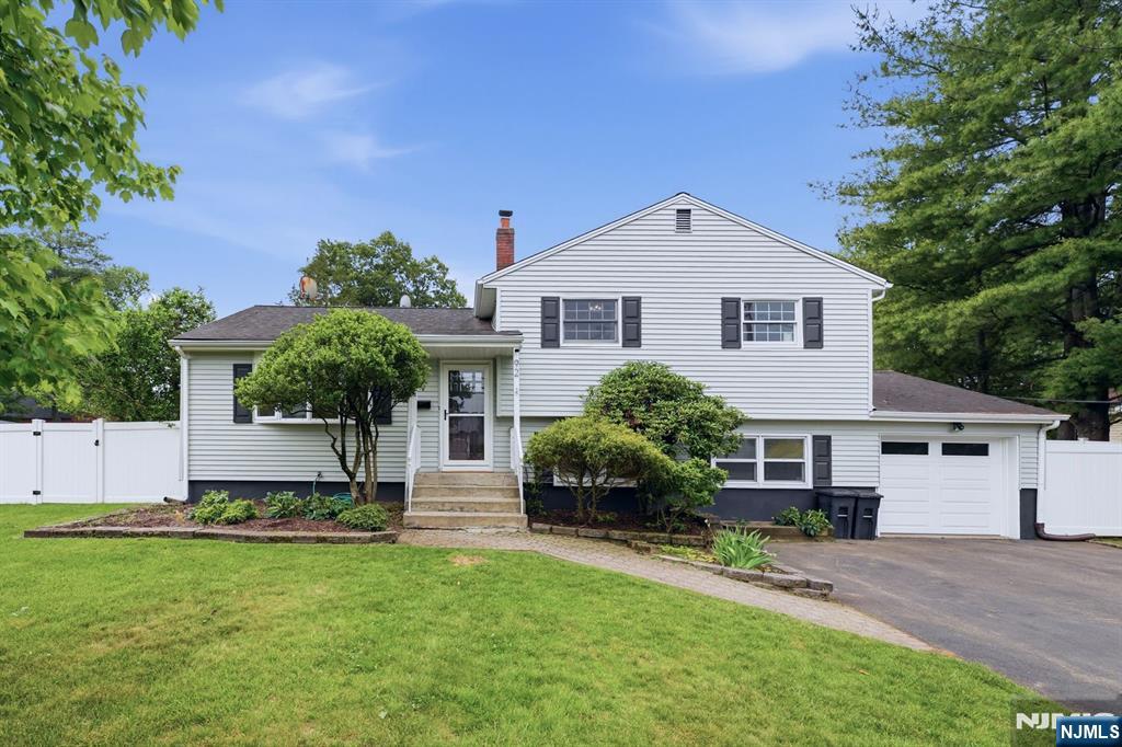 Welcome to this beautifully updated and expanded 4-bedroom, 2-bath home nestled on a dead-end street in Closter. Filled with natural light and thoughtfully designed for today's lifestyle, this home offers a living room that flows seamlessly into the dining room, creating the perfect space for everyday living and entertaining. The updated kitchen features vaulted ceilings, skylight, and opens directly to a sun- lit family room with vaulted ceilings, additional skylight, a fireplace, and walls of windows overlooking the backyard. Upstairs, you'll find three bedrooms and an updated full bathroom. The walk out level provides access to the backyard and garage. It features a recreation room, fourth bedroom, and updated full bathâ€”ideal for guests, extended family, or a home office. The finished basement offers additional living space with updated vinyl flooring and a dedicated laundry area. Situated on a tremendously large, flat, fenced-in property, the expansive deck is perfect for outdoor dining, entertaining, and enjoying the beautiful backyard. Located in one of Bergen County's most sought-after communities, Closter is known for its top-rated schools, vibrant downtown, parks, recreational amenities, and convenient access to New York City. This is a wonderful opportunity to enjoy comfort, space, and an exceptional lifestyle in a premier town.