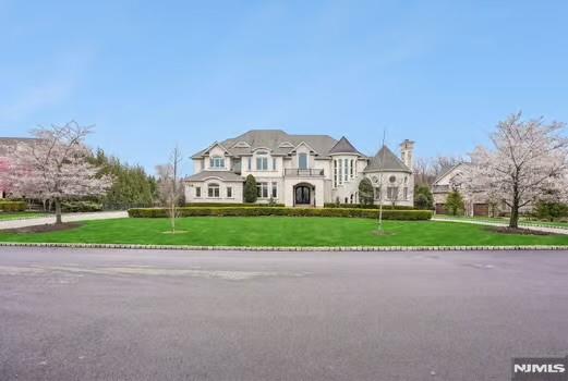 Set within the exceptional Bel Air Woods Enclave, this spectacular custom estate offers nearly 12,000 sq. ft. of luxurious living space, 6 bedrooms, 6 full & 3 half baths. A grand two-story foyer w/sweeping staircase and wrought-iron railings sets the tone for this extraordinary home. Sun-filled entertaining spaces include a dramatic two-story foyer w/ soaring 21-ft ceilings, flor-to-ceiling windows & fireplace, elegant formal dining room w/ tray ceiling, detailed moldings & butler's pantry. Gourmet chef's Kitchen freatures custom cabinetry, granite countertops, premium Wolf and Miele appliances, 2 sinks, 2 dishwashers, oversized center island & breakfast room. Multiple French Doors open to an expansive IPE Deck, Swim Spa and Patio, ideal for indoor/outdoor living. Sun-drenched Library, custom millwork, double height ceiling, fireplace, panoramic windows overlook lush grounds. Desirable first-floor Bedroom,(all bedrooms are en-suite). Luxurious Primary Suite, Tray Ceiling, Fireplace, Sitting Room, Juliet Balcony, two custom walk-in closets and gorgeous marble spa bath. Third-floor multi-purpose room provides flexible living space. Finished lower level w/ 10-ft ceilings include Home Theater, Recreation Room, Gym, Game Room, additional Bedroom & walkout to park-like backyard. Additional highlights; Private Elevator, 3-car Garage, exquisite high-end finishes throughout, prime location close to NYC transportation, shopping, award-winning schools & houses of worship.
