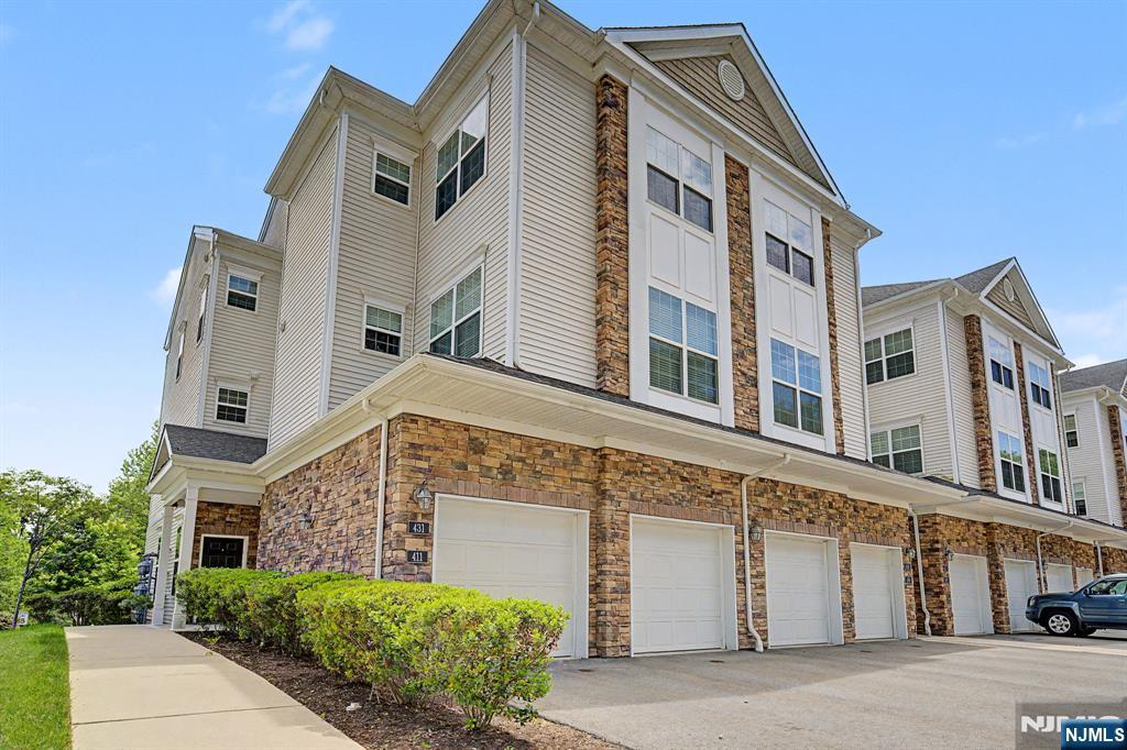 Experience modern luxury in this nearly new end-unit townhome, ideally located in the heart of Rockaway Twp just minutes from vibrant downtown Denville. Thoughtfully designed with soaring 10ft ceilings, oversized windows, & upscale finishes throughout, this home offers the perfect blend of style, comfort, & convenience. A rare feature for townhouse living, this spacious residence includes 3 full baths, providing exceptional flexibility for guests. The stunning primary serves as a private retreat, featuring a large walk-in closet & a spa-inspired en-suite bath complete with double sinks & a separate water closet. The open layout is ideal for both everyday living & entertaining, seamlessly connecting the living room, dining area, & gourmet kitchen. The kitchen is beautifully appointed with SS appliances, granite countertops, abundant cabinetry, a dual-basin sink, & a peninsula with seating. Natural light pours into every room, creating a bright & inviting atmosphere throughout the home. Addtl highlights include a convenient laundry room & a private patio with space for outdoor dining, grilling, & relaxing while overlooking peaceful natural greenery. As an end unit within a quiet & welcoming community, this home offers added privacy while still being just minutes from major highways, shopping, restaurants, & everyday conveniences. This exceptional townhome offers a low-maintenance lifestyle w/o sacrificing space or sophistication.