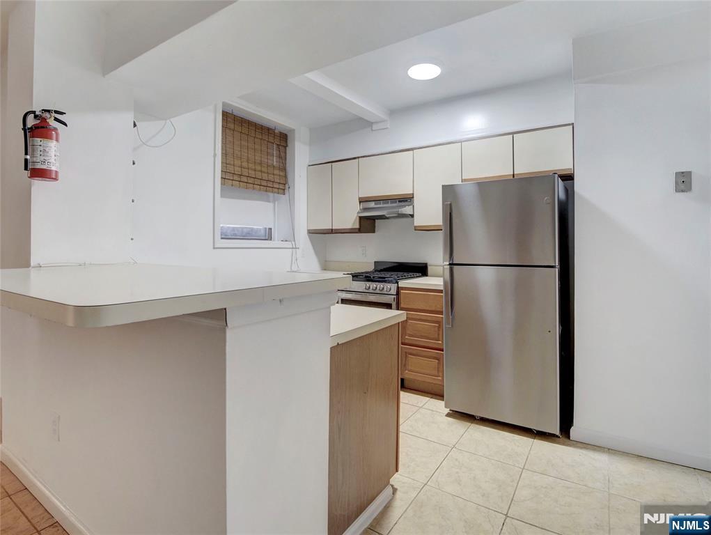 Right in the heart of Orange's new vibrant redevelopment is the opportunity to own a tucked away quiet spot to make home. On the lowest level of this charming brick building sits a move in ready 2 bedroom unit with updated bath, easy maintenance floors, galley style kitchen and combined LR/DR space. Just enough space to downsize to or great opportunity for a condo in a convenient commuter spot - just up the road from NJ Train stop. Also appealing for those needing a second home option for work. Square footage is approx, as per tax record. Non warrantable loan needed (no VA, FHA, Freddie or Fannie Mae will be approved by buyers bank).