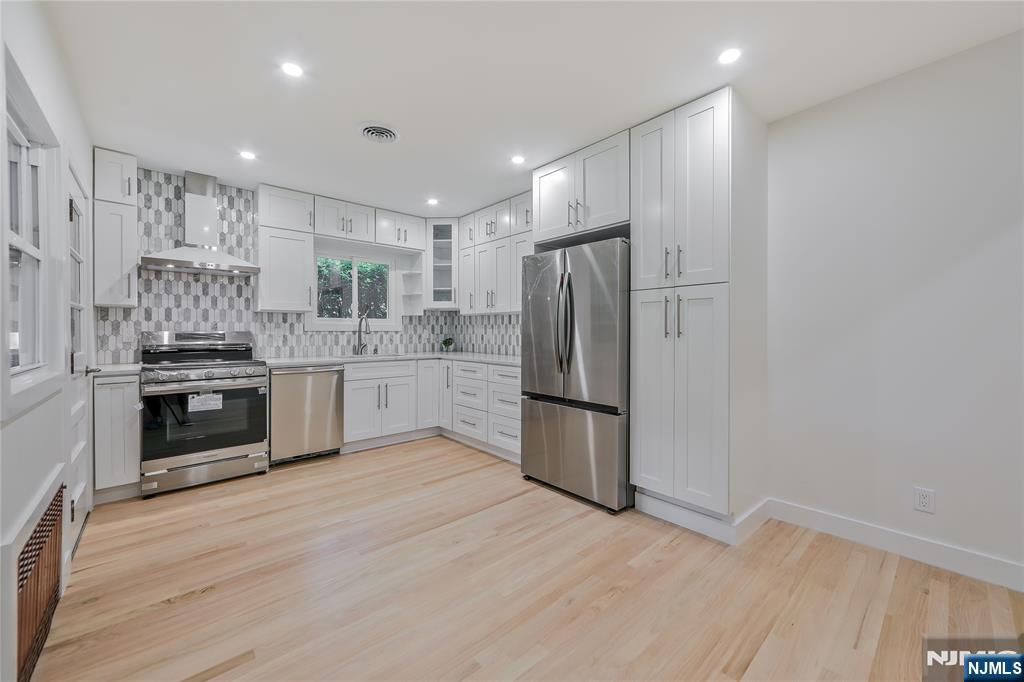 Dream home beautifully renovated! Ranch style home nestled on a peaceful, residential block in Bergenfield, NJ. Perfect for multi-generational living, this home offers a versatile and thoughtfully designed layout featuring bright rooms, custom lighting with dimmers, and two cozy fireplaces for added warmth and charm. Spacious 2 bedrooms, 2 bath first floor with bonus apartment lower level 3 large bedrooms, fireplace, kitchen and a full bath. Enjoy modern comforts with brand-new appliances, including a washer and dryer, and a fully equipped kitchen that opens onto a private backyardâ€”ideal for entertaining friends or relaxing with family. With central air conditioning, a generous 2 car garage plus additional driveway spaces, convenience is at your doorstep. This home's prime location places you just a short walk away from NYC bus stops (only 20 minutes to the George Washington Bridge!), along with local shops, banks, and houses of worship. Make this wonderful home yours todayâ€”schedule your private viewing now and step into comfortable, contemporary living!