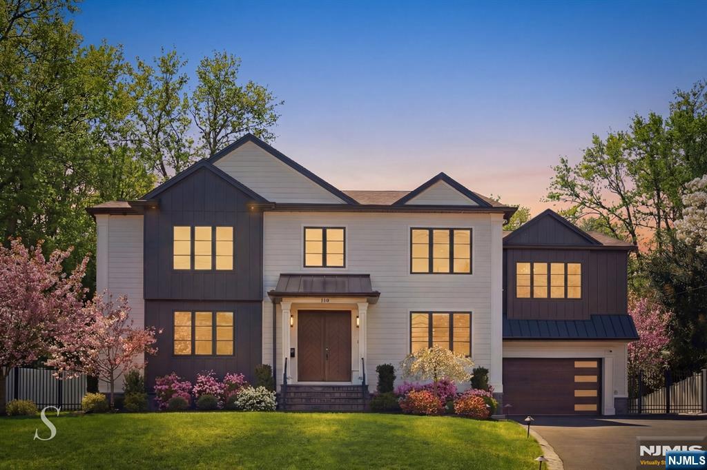 info@116cedarlanecloster.com // Further elevated with extensive, thoughtfully curated upgrades after its 2024 completion, this exceptional 6BR/5.5BA residence in coveted Closter offers a rare fusion of contemporary luxury and timeless craftsmanship across three thoughtfully designed levels. The grand entry welcomes with LED-lit oak stairs, exposed beam ceilings, and a crystal chandelier - setting an unmistakable tone of refinement. The heart of the home is a breathtaking chef's kitchen featuring Calacatta quartz countertops, walnut-and-white cabinetry with gold hardware, professional-grade appliances, and a butler's pantry. The sun-drenched great room with coffered ceilings and French doors opens to an elevated deck and expansive bluestone patio overlooking a private, arborvitae-lined yard. A dedicated home office, guest suite, and generous playroom complete the main level. Upstairs, a dramatic beamed loft lounge with fireplace anchors the bedroom wing. The primary suite features a tray ceiling, dual walk-in closets, and a spa bath with freestanding tub, rain shower, double vanity, and a private fireplace. Each additional bedroom offers an en-suite bath with bespoke tile work. The expansive finished lower level presents limitless possibilities - ideal for a home theater, fitness studio, recreation room, or all of the above. Located minutes from top-rated Closter schools and NYC transit.