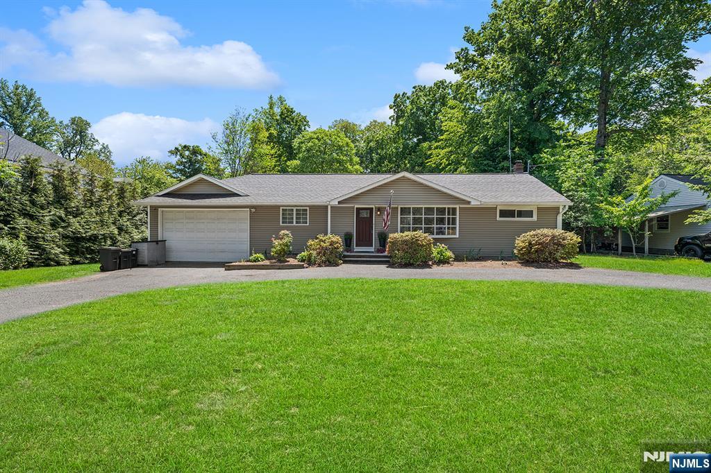 This beautifully renovated and expanded ranch offers the perfect blend of modern comfort and style on a gorgeous half-acre lot. The dramatic two-story family room makes a bold impression, anchored by a cozy wood-burning fireplace. Buyers will love the expansive dining room, which features a separate seating area and overlooks the deep, private backyard. The modern, fully equipped kitchen serves as the central culinary hub, complete with a center island and stylish finishes. For privacy, the primary suite includes its own bath and walk-in closet, while two additional bedrooms share a full hall bath. Hardwood floors tie the entire interior together. Outside, the newly added patio with a pergola and swing provides an incredible setting for outdoor dining. Complete with a two-car garage, circular driveway, central AC, and 3-zone heating, this turn-key property is ready for immediate showings! Perfectly situated in the highly desirable Township of Washington, this neighborhood boasts a welcoming community feel, highly regarded schools, fantastic local parks, and active recreation programsâ€”all while offering a highly convenient commute into New York City
