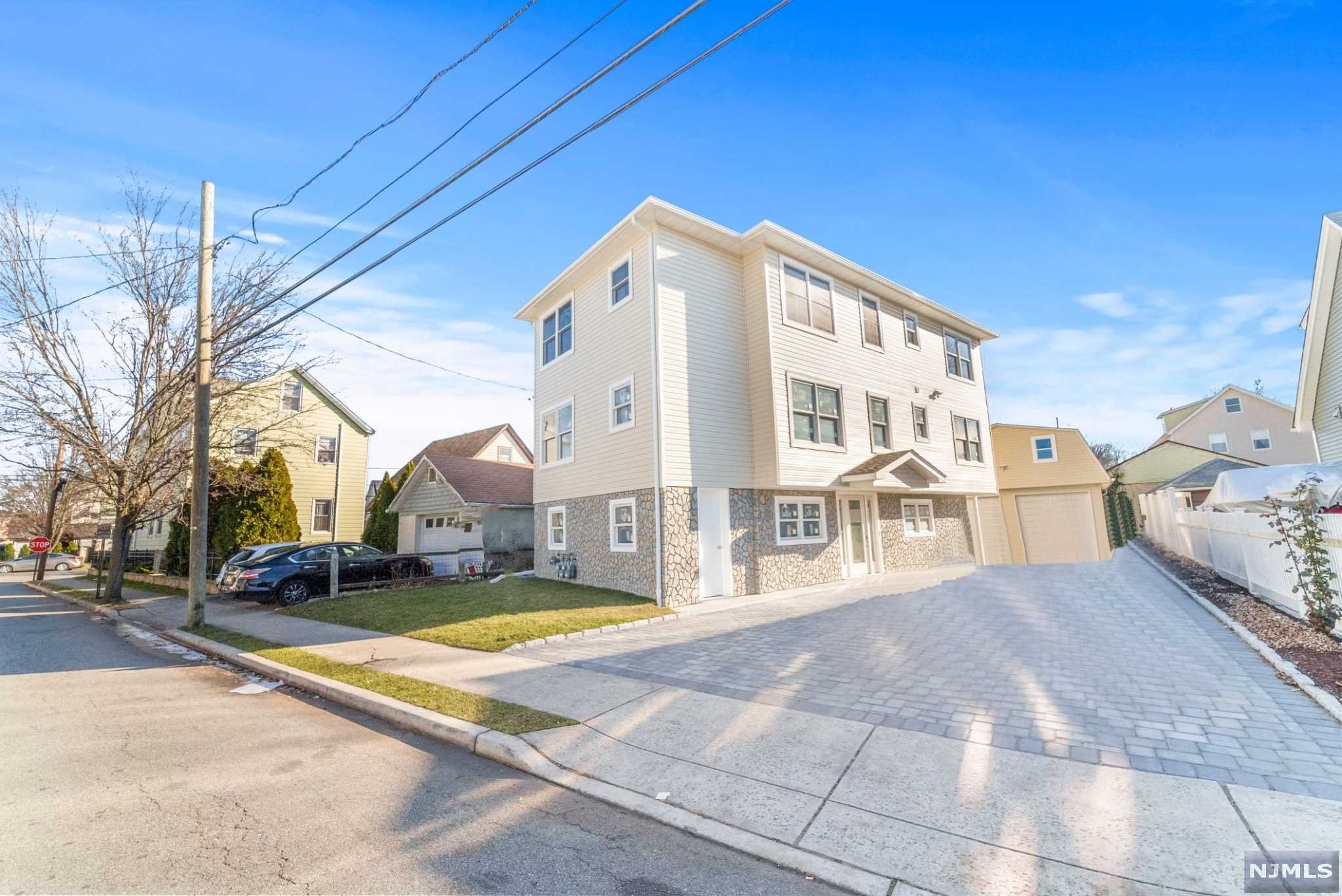 WELCOME HOME! THIS SEMI NEW CONSTRUCTION (FROM FOUNDATION UP) TWO FAMILY HOME BOASTS 10 RMS, 4 BDRMS & 2 FULL BATHS. ENTER THROUGH THE FRONT & INTO THE 1ST UNIT WHICH BOASTS H/W FL, 2 BDRM, 1 FULL BTH & BRAND NEW MODERN KIT W/ CENTER ISLAND, GRANITE COUNTERTOPS, SOFT CLOSE CABINETS & AN OPEN LAYOUT. THE 2ND UNIT IS IDENTIAL TO THE 1ST. THE BASEMENT IS UNFINISHED & HAS A WASHER/DRYER HOOK UP, TANKLESS WATER HEATERS, 2 ZONE CENTRAL & FORCED AIR. THE YARD & DRIVEWAY IS FULLY PAVERED & FENCED IN. THERE IS A 2 CAR DEATTACHED GARAGE W/ PLENTY OF RM FOR A THEATER RM IN THE UPPER LEVEL. COMMUNTER FRIENDLY ! AGAVE RESTAURANT LOCATED AROUND THE CORNER!