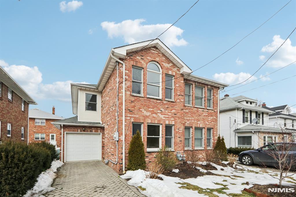 Welcome to this well-maintained brick front Colonial offering a spacious and functional layout filled with natural light throughout. The first floor features a bright living area with hardwood floors and recessed lighting, flowing into a generous family room and an updated kitchen with granite countertops, stainless steel appliances, and ample cabinetry. Upstairs offers well-proportioned bedrooms with excellent closet space and hardwood flooring, including a spacious primary bedroom with multiple closets, along with clean, well-kept bathrooms with neutral finishes. The finished lower level provides a large versatile recreation space with sliding doors to the backyard, ideal for a home office, gym, or entertainment area, and includes a washer and dryer for added convenience. Completing the home is a private backyard, attached garage, and driveway parking, all conveniently located near transportation, shopping, and local amenities for comfortable everyday living.