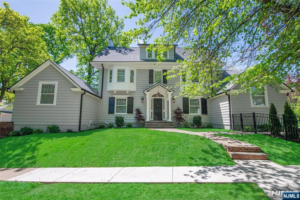 This Stately Glen Ridge Colonial offers 5 bedrooms and 5 baths, blending downtown vibe with suburban tranquility. Renovated to restore its grandeur with modern updates, it features over 4000 sq ft of living space, a charming entryway, classic shutters, and leaded glass windows. The first floor includes a formal foyer with custom lighting, a living room with a fireplace, French doors to a casual den, full bath, mudroom, spacious dining room, butler's pantry, and sliders to the backyard. The dramatic kitchen has vaulted ceilings, marble tiles, custom lighting, a large center island, oversized windows, and rear yard views. The second floor offers the primary suite with a spa bath and spacious closet, plus 2 additional bedrooms and a main bath with high-end finishes and double sinks. The third floor features a private suite with a full bath, 2 more bedrooms, and an additional living room. The finished basement includes a family room with a wet bar, full bath, fireplace, and informal living space for casual entertaining. The beautifully landscaped rear and side yards provide a perfect private oasis for al fresco entertaining and relaxing. This home is a seamless blend of history, thoughtful updates, and luxury, and is moments away from the NY train, highly rated schools, parks, and wonderful amenities.