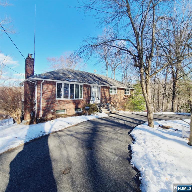 Nestled in a highly sought-after neighborhood, this custom-built, all-brick home is full of potential. The main level features 3 spacious bedrooms, including a primary ensuite, 1 of 2 wood burning fireplaces in a large living room, and a very spacious eat-in kitchen with separate dining room. Hardwood floors under existing carpet. The ground level has a separate entrance, two bedrooms, kitchen, living area with 2nd fireplace and a screened in porch. Most of the double-hung windows are new! All appliances are included, some of them newer. Zoned to allow for two boarders, this home is an excellent opportunity for multi-generational living. The large, full unfinished walkout basement presents a blank canvas for additional living space. Situated on nearly an acre. There's a very convenient horseshoe driveway in front of the house. Once updated, this well-built home can be transformed into a stunning residence in an unbeatable location.