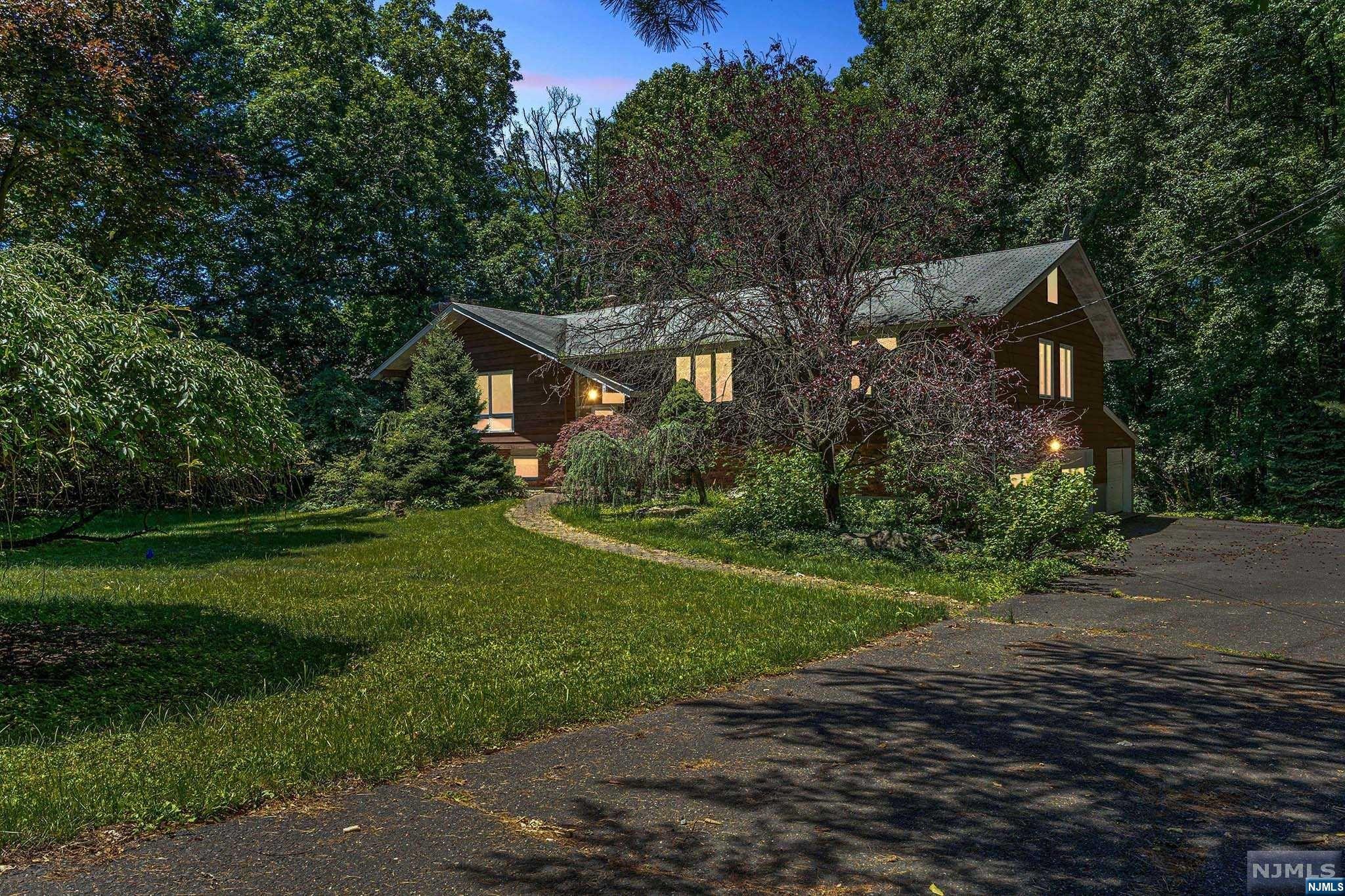 This unique home is nestled on 1.3 acres of land on a very quiet street in sought-after Alpine, NJ with just a 15-minute drive down the Palisades Parkway & over the George Washington Bridge to be in NYC. Home boasts: 4-bedrooms, den, two wood burning fire places, formal dining room, 3-full baths, 3-cars built-in garage, sliding doors leading to large deck overlooking amazing nature of back yard. Live as close to NYC in your own calm natures sanctuary with this one of a kind opportunity. Plans and permit are in place for a new septic system.