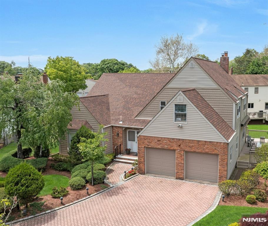 Great Price Reduction! Welcome to a stunning updated expanded &timeless col showcasing 5BR/3.5 Baths all within a top-rated blue ribbon school district near houses of worship &NY transp. Step into a grand dbl entry foyer w/Cath Ceilings &adorned with an antique chandelier. Entertain in an expansive LR w/bow windows &HW floors. Opens to DR that is highlighted by a showstopping chandelier &travertine marble tile flooring. Updated well-appointed chefs kit w/granite counters, premium monogram SS appliances, 6 burner stove w/oven, wall-oven/warming draw &microwave w/Classy cherrywood cabinets &under cabinet lighting. Breakfast rm w/door out to huge 2 tier deck that steps out to BBQ grill &retractable awning. Adjoining spacious FamRm/FPL. Laundry &PR complete this level. Imagine 5 total BRs on the second level. Retreat to tranquil Primary BR w/2 WIC & private en-suite Fbath. Four addâ€™l BRms & Hall bath w/dbl sinks &jacz tub. Spacious fully fin-bsmt w/rec room, wet-bar, ample storage, closets& fBath. Attention to detail, beautifully updated &expanded. A list is provided which includes paver drive& walkway, 4 Z heat&AC, security system, 5 Zsprinklers, crown molding, HW floors, recess lighting &built-in speakers. This pristine home is the perfect blend of Elegance &functionality. Enjoy a serene private picturesque yard &notice a babbling brook at the rear. Sold as is with no known defects. You can have it all, updated home on a cul-de-sac, great neighborhood all in a Top Location!