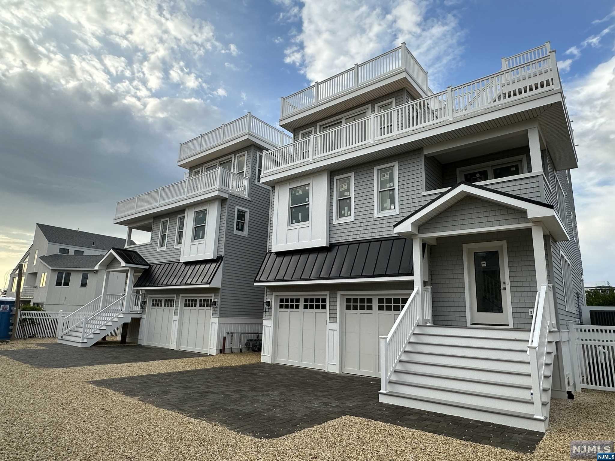 North Beach. Located on a private drive, one off the bay in North Beach, this townhouse new development has the feeling of two single family homes connected by a covered breezeway. Deeded with ocean and bay access, each unit offers 2950 sqft of 3-levels of reversed living designed with entertainment in mind. Complete with 5 bedrooms, 4 full baths, 2 half baths, family room, custom kitchen with quartz counters, fireplace, shiplap accents, elevator, 3 levels of decks including large roof tops with bay views from each...the list is endless. 5th bedroom can be turned into a Den/ TV room, if desired. When you are ready to relax outside, the bay is a stone throw away or travel up your private lane to your deeded beach access or simply stay home in your private fenced in yard complete with paver patio and pool. Broker / Construction manager is available to review plans and a site visit. Drivebys are welcome but we ask do not walk the property without an appointment.