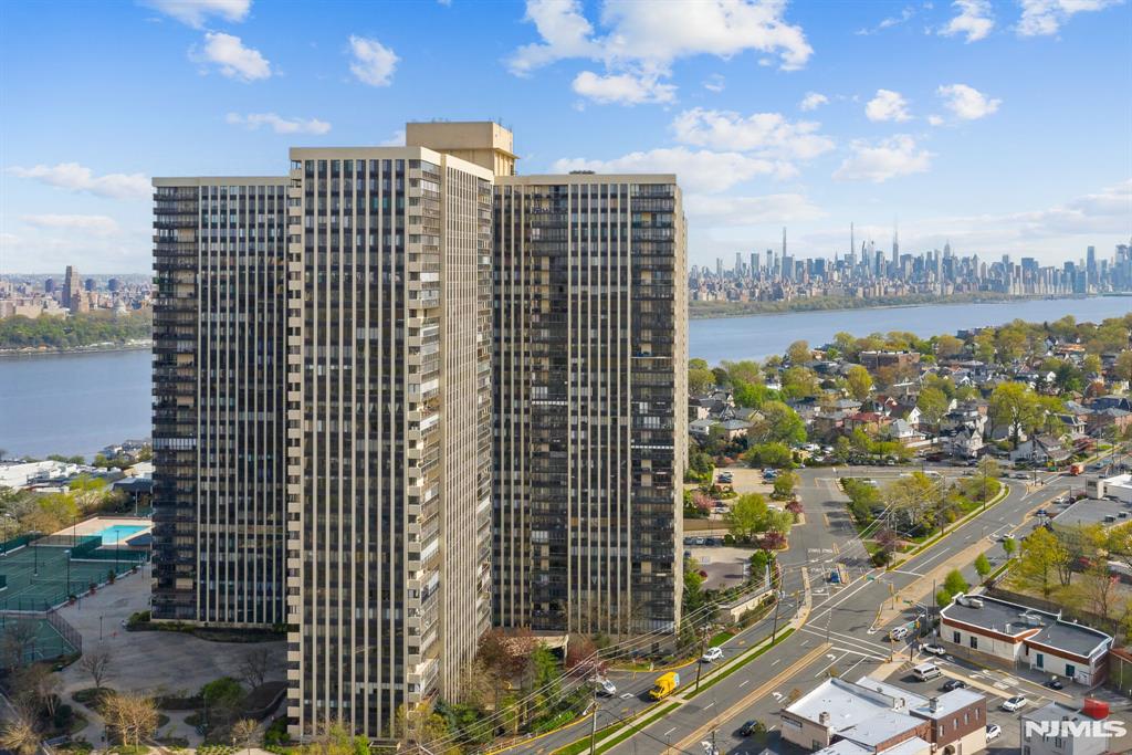Perched high on the 21st floor, this bright and incredibly spacious 3-bedroom, 3-bathroom corner condo offers sweeping, breathtaking views including partial vistas of the Hudson River. Freshly painted throughout and exceptionally clean, this expansive layout is blank canvas awaiting your personal design and decorating ideas! Property Highlights: Primary Suite: Features a private en-suite bath and multiple walk-in closets. Guest Suite: Generously sized second bedroom complete with its own private bath. Third Bedroom: Spacious room with an abundance of closet space. Living & Dining: A massive, open living and dining area with sliding glass doors that lead to a private, enclosed terraceâ€”perfect for year-round outdoor enjoyment. Kitchen & Storage: A classic, vintage eat-in kitchen ready for custom modern updates, complemented by a hallway pantry and multiple deep hall closets. Luxury Building Amenities: Your monthly HOA fee covers premium building perks including 24/7 doorman security, a sparkling outdoor pool, beautifully maintained common areas, and a brand-new, state-of-the-art gym. Don't miss the chance to customize this high-rise gem into your ultimate dream home
