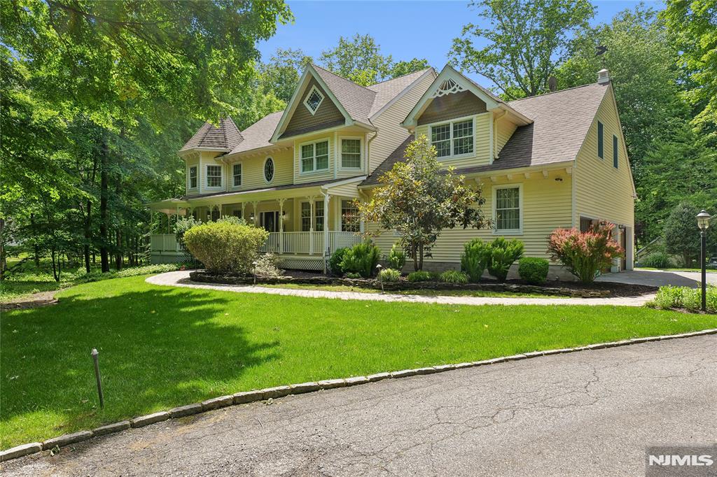 Nestled on a spectacular 4.2-acre park-like setting, 4,305 square foot stunning 5 bedroom. 4 full-bath center hall Colonial with wrap around porch offers extraordinary blend of timeless elegance and natural beauty. Surrounded by lush landscaping, the sprawling property creates a private retreat unlike any other. A grand 2 story entry welcomes you into spacious, light-filled living areas designed for both comfortable everyday living and effortless entertaining. A generous floor plan features beautifully proportioned rooms, providing ample space for family and guests alike. Step outside and discover a true backyard sanctuary. Meandering walking paths wind through the picturesque grounds, leading past a tranquil koi pond, a gentle babbling stream, and thoughtfully designed outdoor gathering spaces. Paver and masonry hardscaping. Offering unmatched privacy, breathtaking scenery and endless possibilities to enjoy nature, this property is a rare opportunity to own your own private estate.
