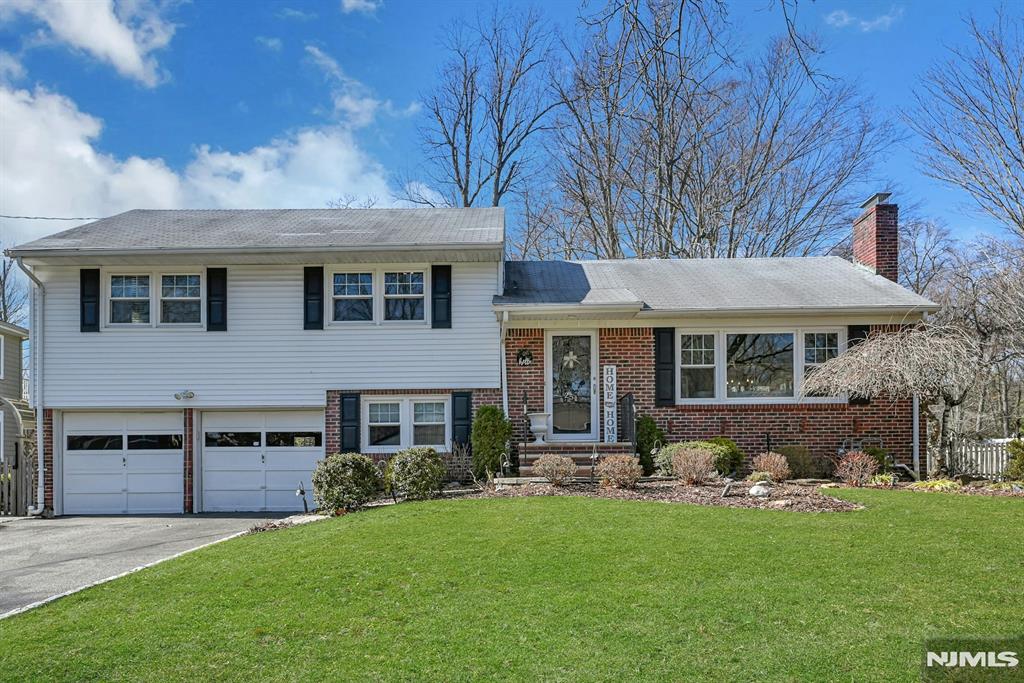 This sophisticated split level home perfectly blends classic charm with modern upgrades, offering a bright and airy layout designed for both comfort and entertaining. The heart of the residence is a functional chefâ€™s kitchen featuring premium stainless steel appliances, granite countertops, gas range and radiant heated floors. The space is elevated by a unique blend of warm wood and cream cabinetry, complete with a built-in wine rack and glass-front displays. Flowing from the kitchen is a sun-drenched dining area with elegant wainscoting and a classic chandelier, offering views of the large lush backyard. Pristine hardwood floors and updated recessed lighting create a warm, inviting atmosphere. The primary suite with full bath and walk in closet. Main bath finished in traditional marble for a modern but classic feel. Outside, the expansive fenced-in yard is for outdoor gatherings or sports oriented family. A true suburban sanctuary on a flat 1 acre lot only half a block to Anne Blanche Elementary School.