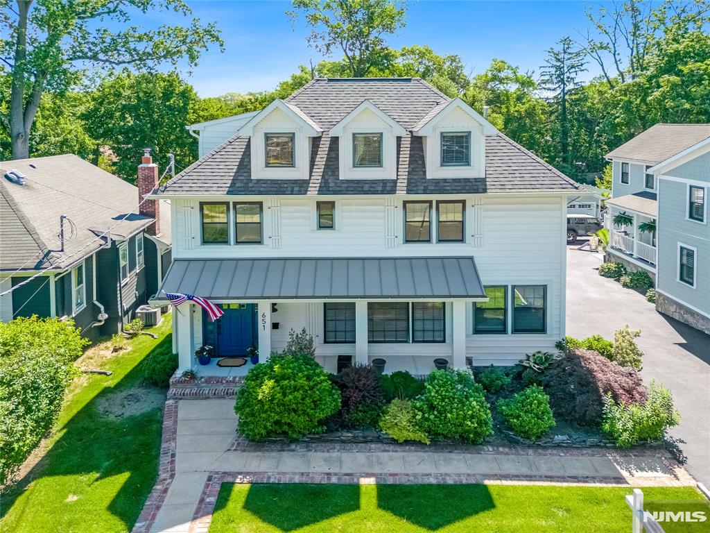 Experience living in this exquisitely renovated Montclair residence, thoughtfully rebuilt in 2019 with exceptional craftsmanship and premium finishes throughout. A dramatic two-story foyer welcomes you into bright, open living spaces designed for both everyday comfort and elegant entertaining. This home offers 5 bedrooms, including a spectacular primary suite featuring a 14-foot walk-in closet, a spa-inspired bath, and a private balcony. There are 5 Full Bathrooms and a first floor powder room. The stunning double island chef's kitchen is equipped with high-end Thor appliances, custom cabinetry, and designer finishes. There is a walk-in pantry and a mudroom / family entrance from the attached oversized two car garage. Extra living spaces include a first floor office, a top floor loft and a lower level media room. Additional upgrades HVAC systems with two-zone heating and cooling, Nest thermostats, Restoration Hardware fixtures, custom window treatments, smart locks, and a fully redesigned landscape with a four-zone sprinkler system. The private backyard was completely rebuilt with a new patio and built-in planters, creating the perfect outdoor retreat.. A rare opportunity to buy a truly turnkey luxury home in one of Montclair's most desirable neighborhoods.