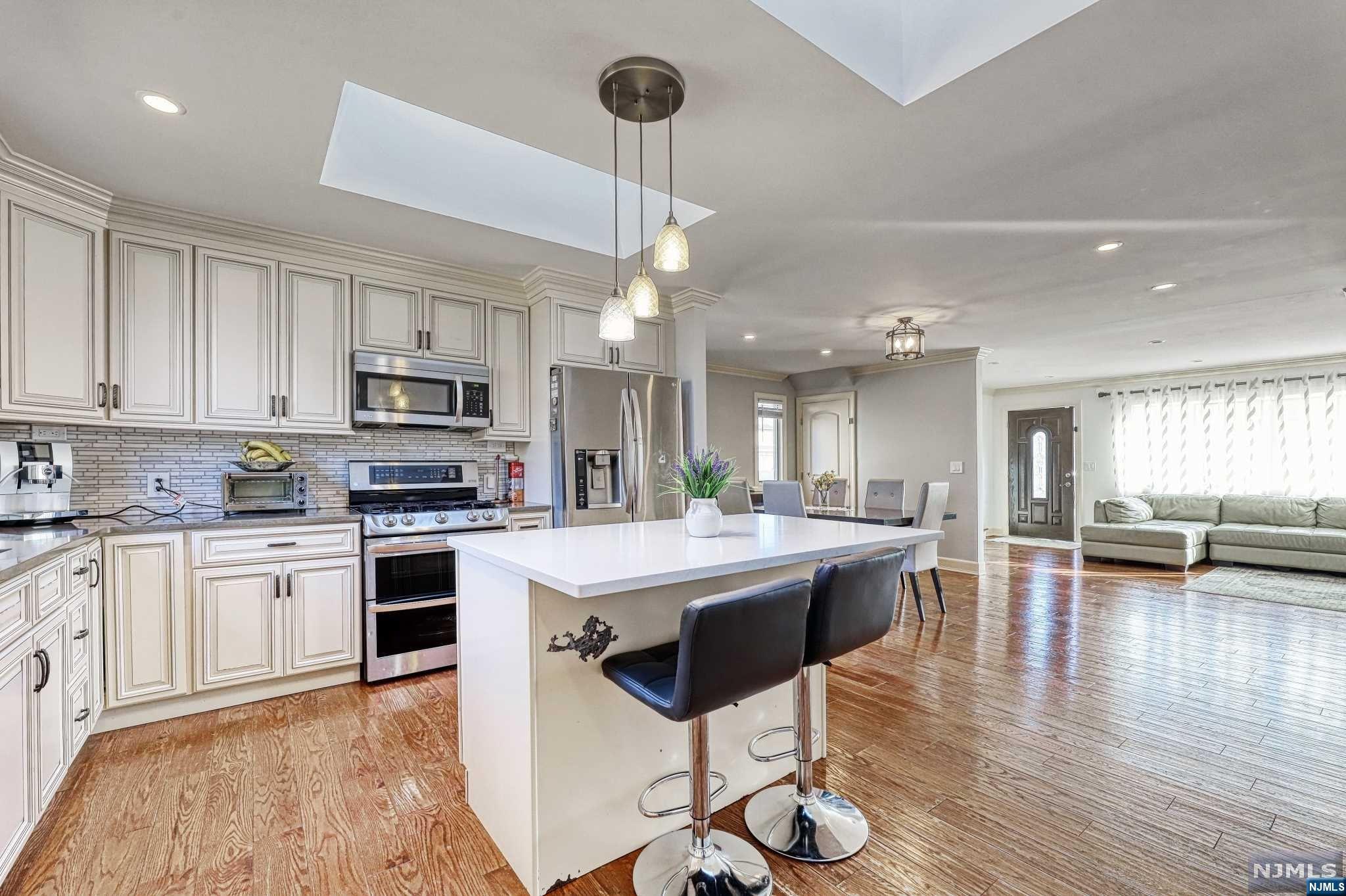 Welcome to this beautiful turn-key deceptively large custom renovated & expanded cape in the desired prime neighborhood of Clifton! The first floor features an open concept, nice size living room, modern kitchen with skylights, island with quartz countertop, stainless steel appliances, dining room, 2 bedrooms, full bath with marble tiles. The second floor offers a nice size bedroom with an office & full bath, hand craped hardwood floors , central heat & AC waterproof finished basement, a large fenced in backyard, 1 car garage, paved driveway for 4 cars. Roof, siding and driveway were done in 2019. Close to NY transportation, schools, parks, restaurants, shops and all major highways. Come see this home before it's too late.