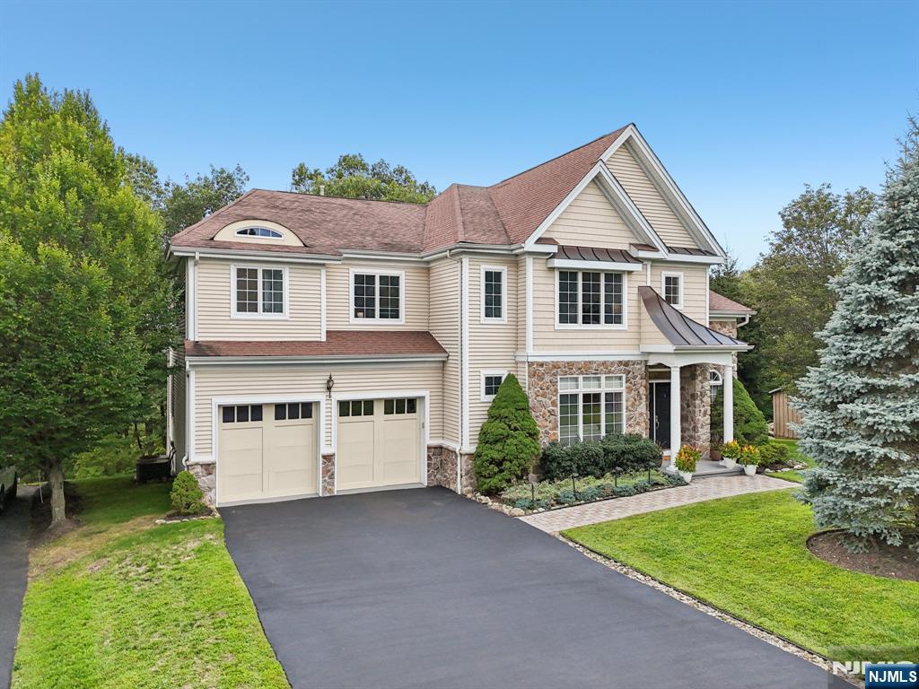 Pinnacle of luxury living in this breathtaking mountain top retreat located in the prestigious Cotswold Estates of the Ramapo River Reserve. Nestled on a peaceful cul-de-sac, this stunning 4-BR, 4.5-BA home offers unparalleled views of the mountains. Lovely entrance w/ reception area, formal dining room, and impressive 2-story foyer w/ grand staircase and chandlier. Beautifully refinished hardwood floors throughout lead to an expansive great room w/ incredible ceiling height, large windows, and an inviting fireplace. Open-concept kitchen features a convenient walk-out deck where you can enjoy panoramic mountain vistas. The adjacent office overlooks a fantastic yard, allowing you to work in tranquility, reminiscent of living in a treehouse perched high above the world. Primary suite is a true sanctuary: 2 spacious walk-ins, and beautifully newly renovated bathroom w/ luxurious soaking tub and sweeping views of the mountain ridge. On the 2nd floor, 3 additional bedrooms feature en suite baths thoughtfully designed and recently renovated. Turn-key property high atop the Ramapo mountains includes a fully finished walk-out basement level with 2nd patio below upper deck. Tons of natural light floods the home, bright and inviting at every turn. Incredible amenities including a lake, fitness center, clubhouse, pool, playgrounds, and hiking trails all just steps from your front door. Two-car garage and an open layout make this home as practical as it is beautiful!