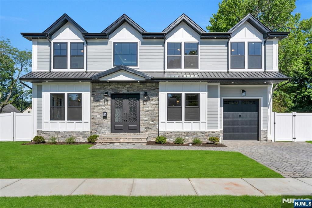 Stunning 7-bedroom 5.5 bath new construction home located in most desirable Bergenfield neighborhood. The house features a 20-foot entry way and 9-foot ceilings throughout the first floor and lower level. The main level features a living room, formal dining room with washing station, family room with gas fireplace room leading seamlessly into a large modern eat-in-kitchen, complete with high end double appliances, quartz countertops and an over-sized island. The walk-in pantry, mud room off the garage and powder room completes the first floor. The second level features a primary suite with trey ceilings, custom walk-in his and her closets and spa-like master bath. 4 additional bedrooms 2 with ensuite bathrooms, another full bathroom and laundry complete the second floor. The lower level has a large recreation area, 2 spacious guest rooms with egress windows, a full bathroom and utility room. The home features radiant heat throughout the basement, 3 zone heat, 2 zone ac, a whole house generator, inground sprinklers and much more. 10-year NJ Homeowner warranty provided upon purchase. Close to multiple houses of worship, parks and transportation.