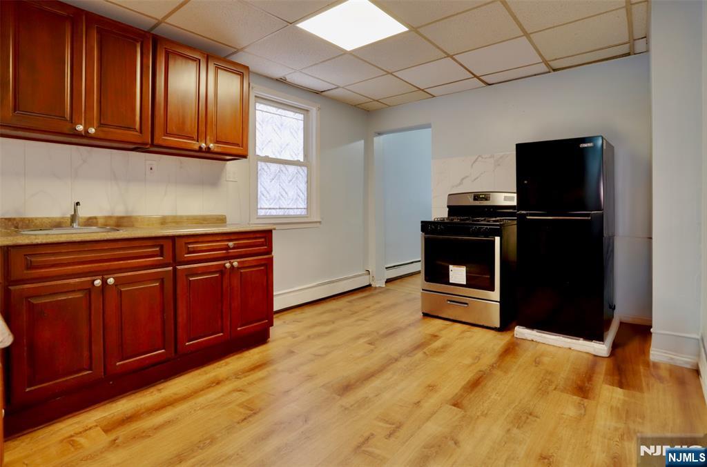 Welcome to this charming 3-bedroom + den duplex in the heart of Bloomfield, where modern convenience meets classic comfort. This delightful home features an open-concept layout that seamlessly connects the living room and dining area, offering ample space for relaxation and entertaining. Natural light pours through large windows, enhancing the warm and inviting ambiance. Hardwood flooring throughout. Shared backyard offers a perfect outdoor retreat. Located on a tranquil street, this duplex enjoys the perfect balance of privacy and accessibility. A shopping plaza is conveniently located right across the street, and bus stops and a train station are nearby for effortless commuting. Plus, you're just minutes away from local shops, restaurants, parks, and schools, making this an ideal place to call home.
